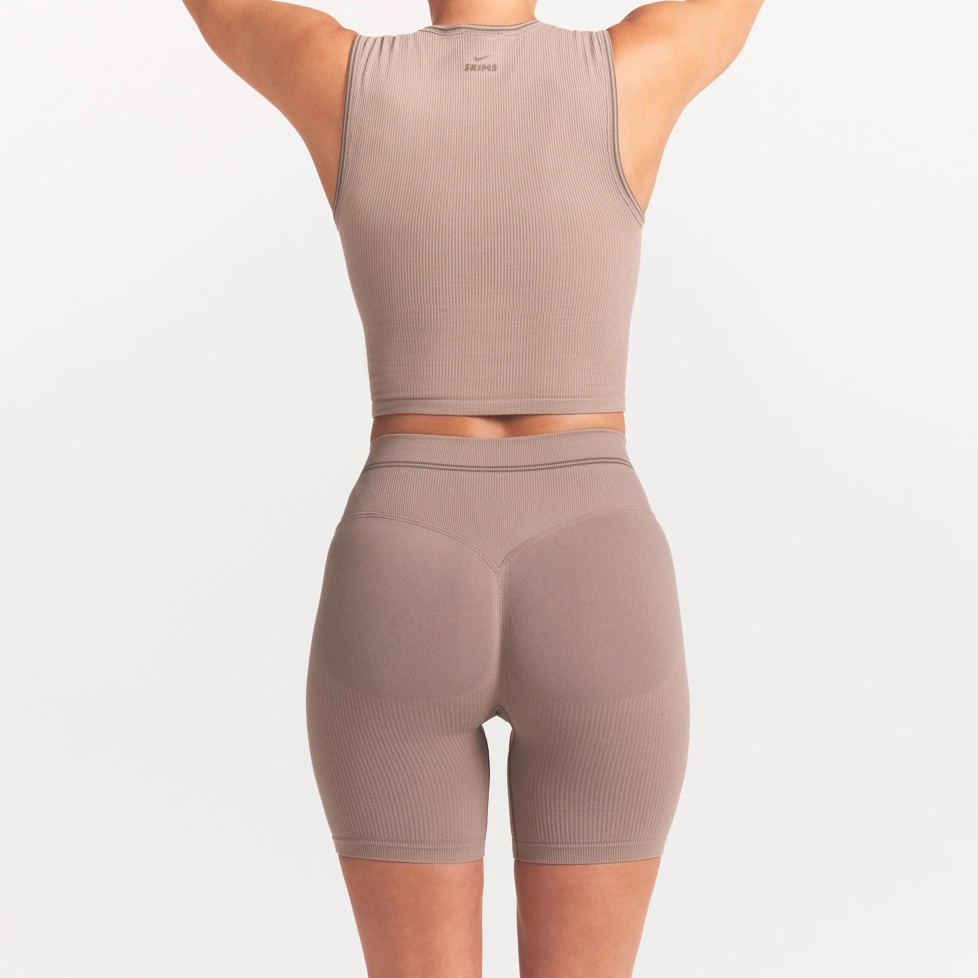 NikeSKIMS RIBBED SEAMLESS 5" BIKER SHORT | DRIFTWOOD ON A MODEL SIDE VIEW @ | FOCUS: 0.0, 1.0, 0.9