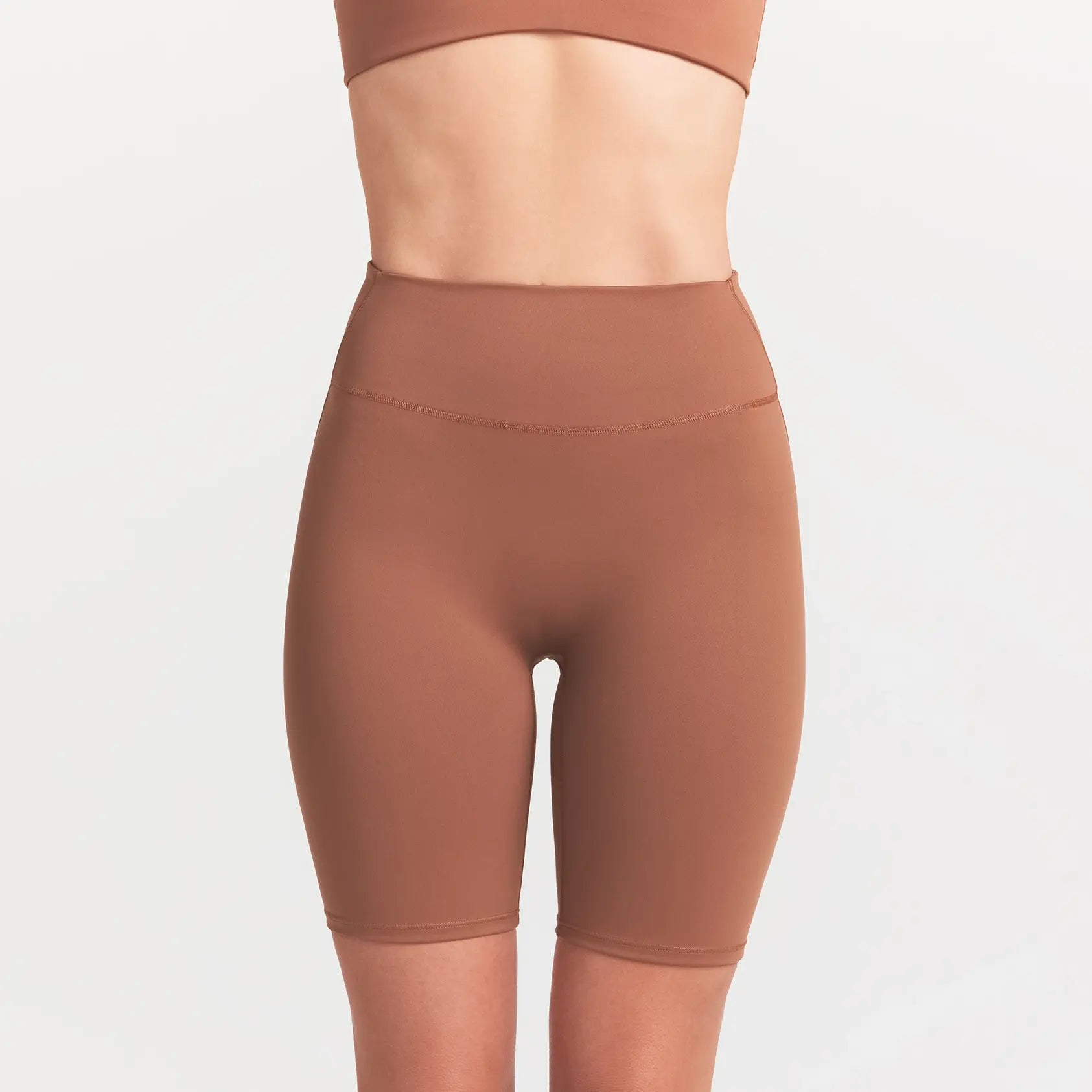 NikeSKIMS MATTE 7" BIKER SHORT | CAROB BROWN ON A MODEL SIDE VIEW @ | FOCUS: 0.0, 1.0, 0.9