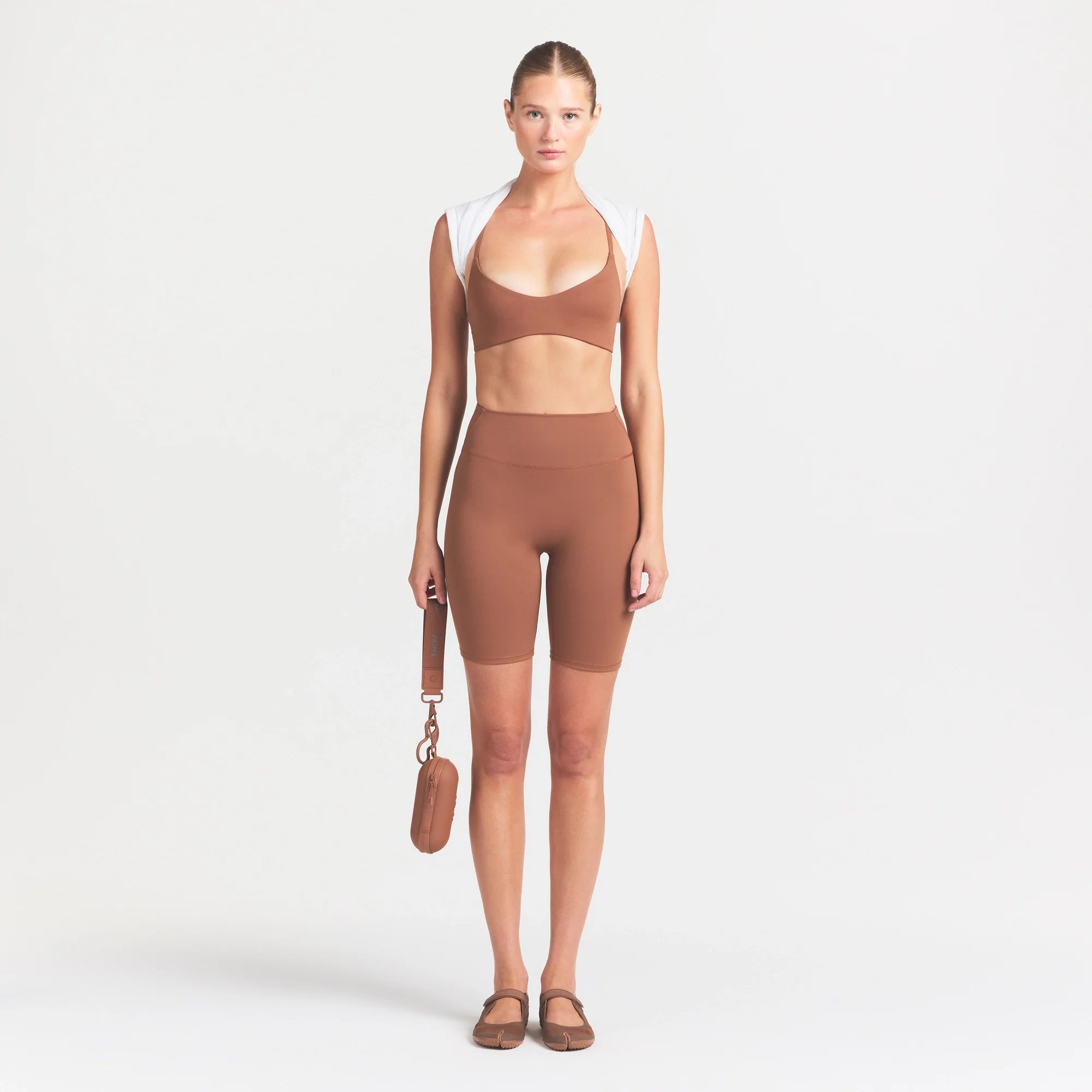 NikeSKIMS MATTE 7" BIKER SHORT | CAROB BROWN ON A MODEL FRONT VIEW @ | FOCUS: 0.0, 1.0, 0.9