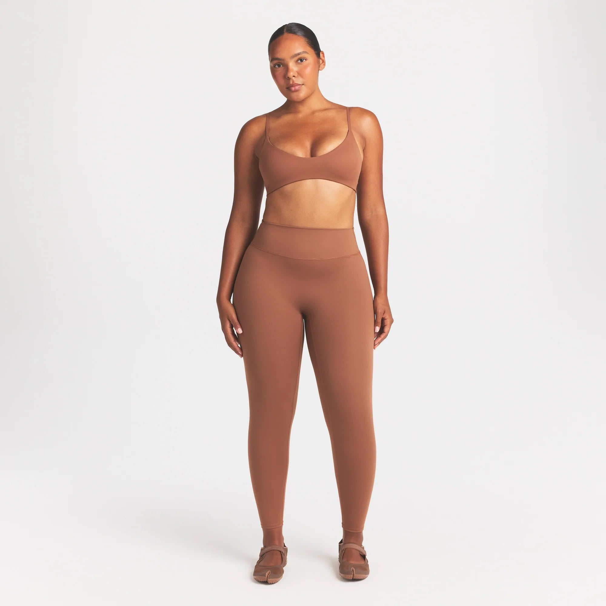 NikeSKIMS MATTE 26" LEGGING | CAROB BROWN ON A MODEL FRONT VIEW @ | FOCUS: 0.0, 1.0, 0.9