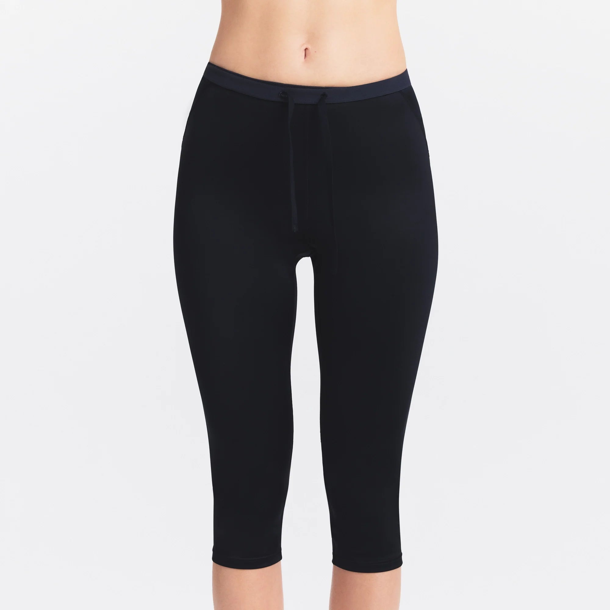 NikeSKIMS SATIN SHINE CAPRI 17" LEGGING | OBSIDIAN ON A MODEL SIDE VIEW