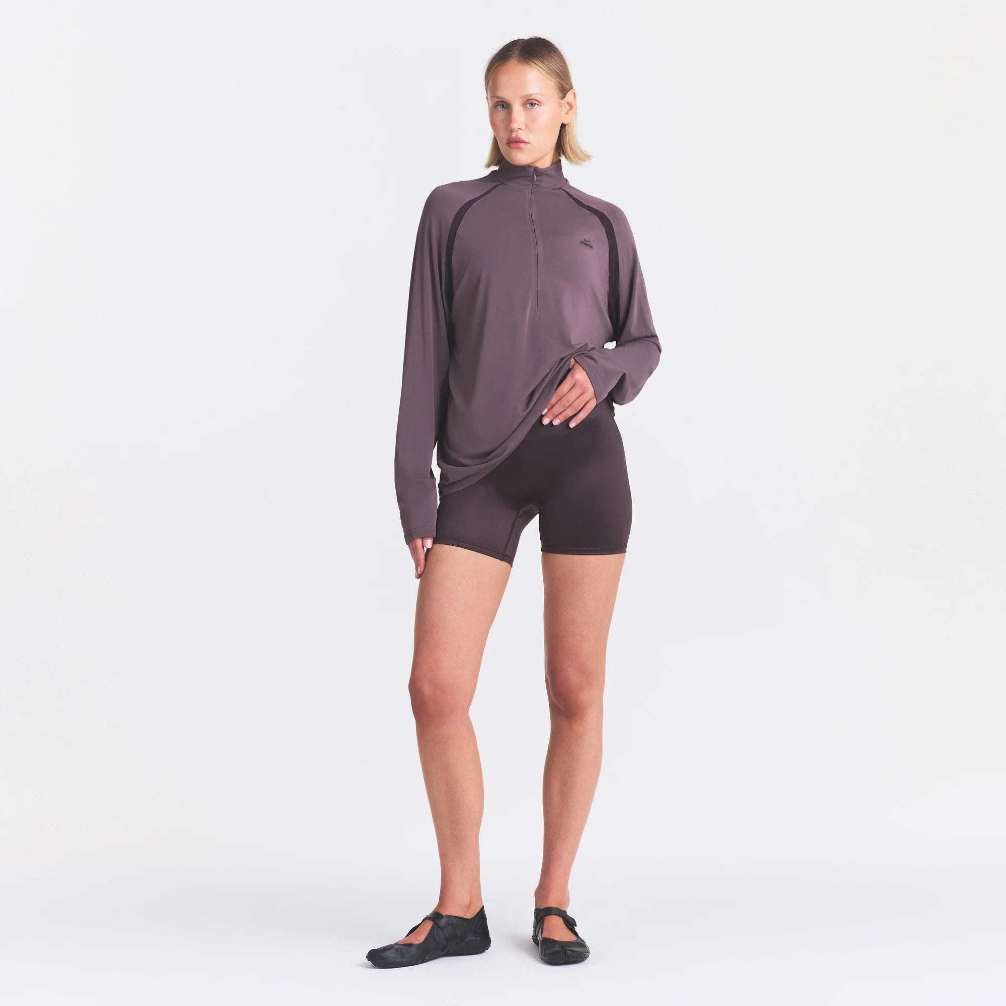 NikeSKIMS SATIN SHINE BONDED WAIST 5" BIKER SHORT | PHOENIX ON A MODEL FRONT VIEW