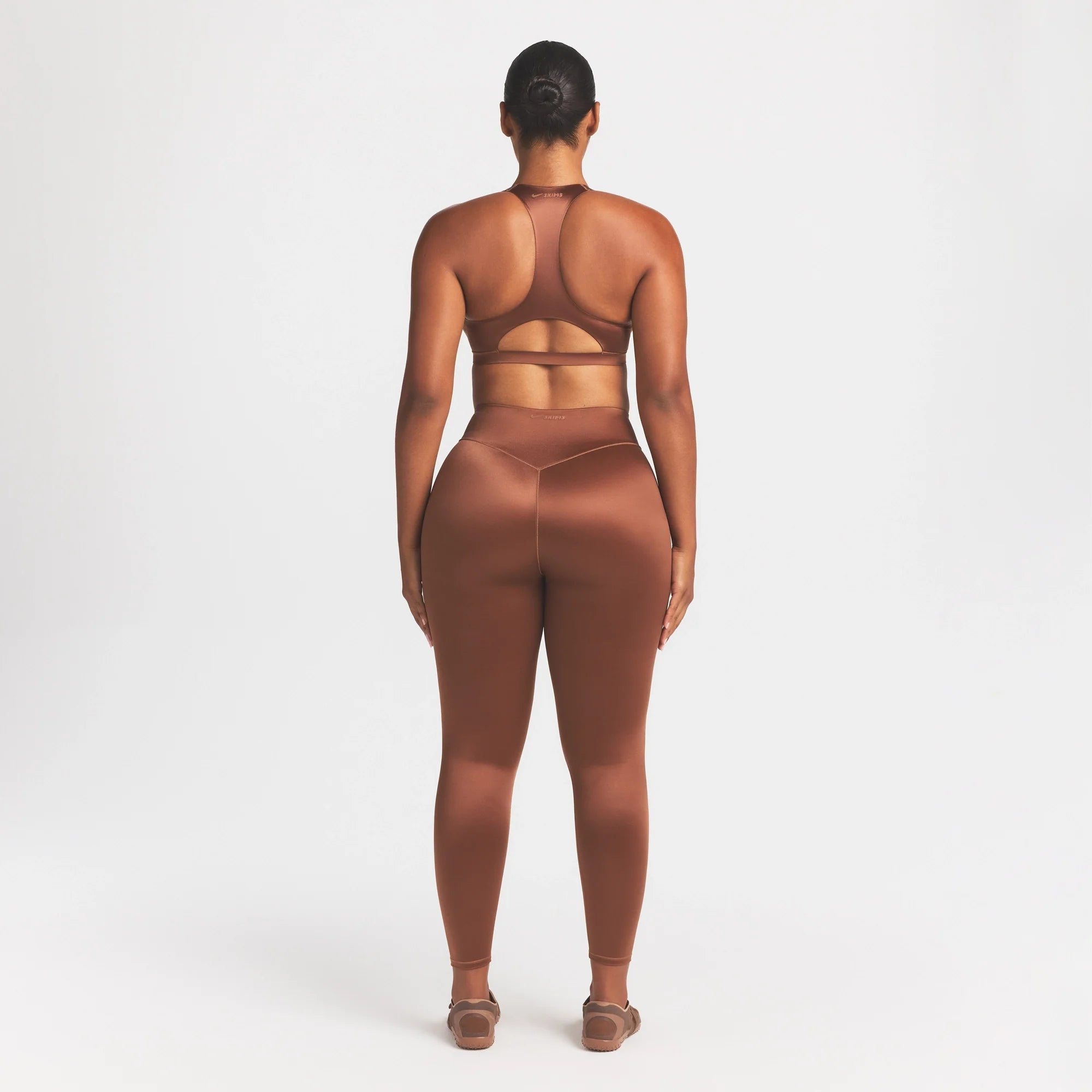 NikeSKIMS SATIN SHINE BONDED WAIST 26" LEGGING | CAROB BROWN ON A MODEL FRONT VIEW @ | FOCUS: 0.0, 1.0, 0.9