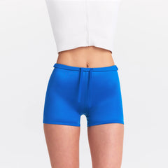 NikeSKIMS SATIN SHINE DRAWCORD 2" SHORT | COBALT ON A MODEL SIDE VIEW