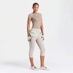 NikeSKIMS STUDIO STRETCH 17" CAPRI LEGGING | LINEN ON A MODEL FRONT VIEW @ | FOCUS: 0.0, 1.0, 0.9