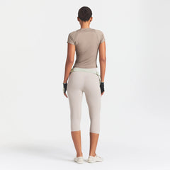 NikeSKIMS STUDIO STRETCH 17" CAPRI LEGGING | LINEN ON A MODEL FRONT VIEW @ | FOCUS: 0.0, 1.0, 0.9