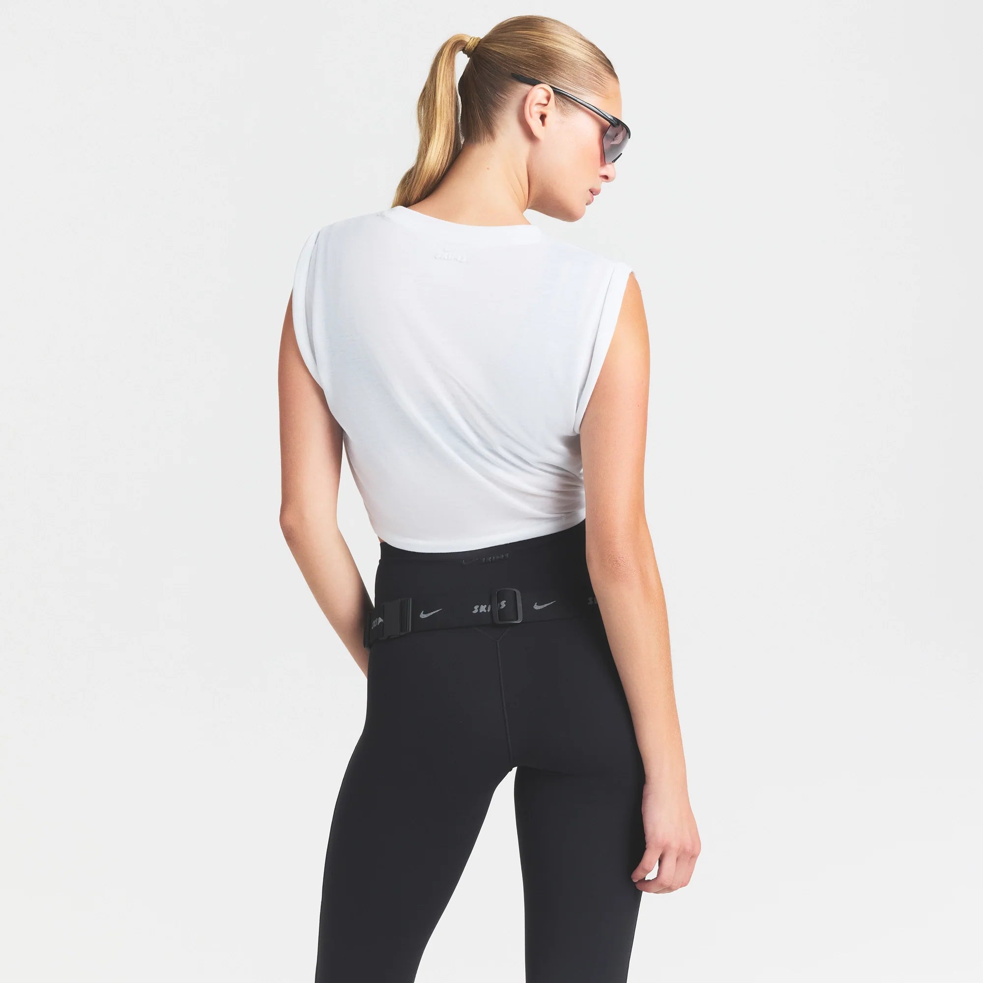 NikeSKIMS PERFORMANCE COTTON BLEND CROP TWIST TANK | SNOW & LAYS FLAT ON A WHITE BACKGROUND | FLT