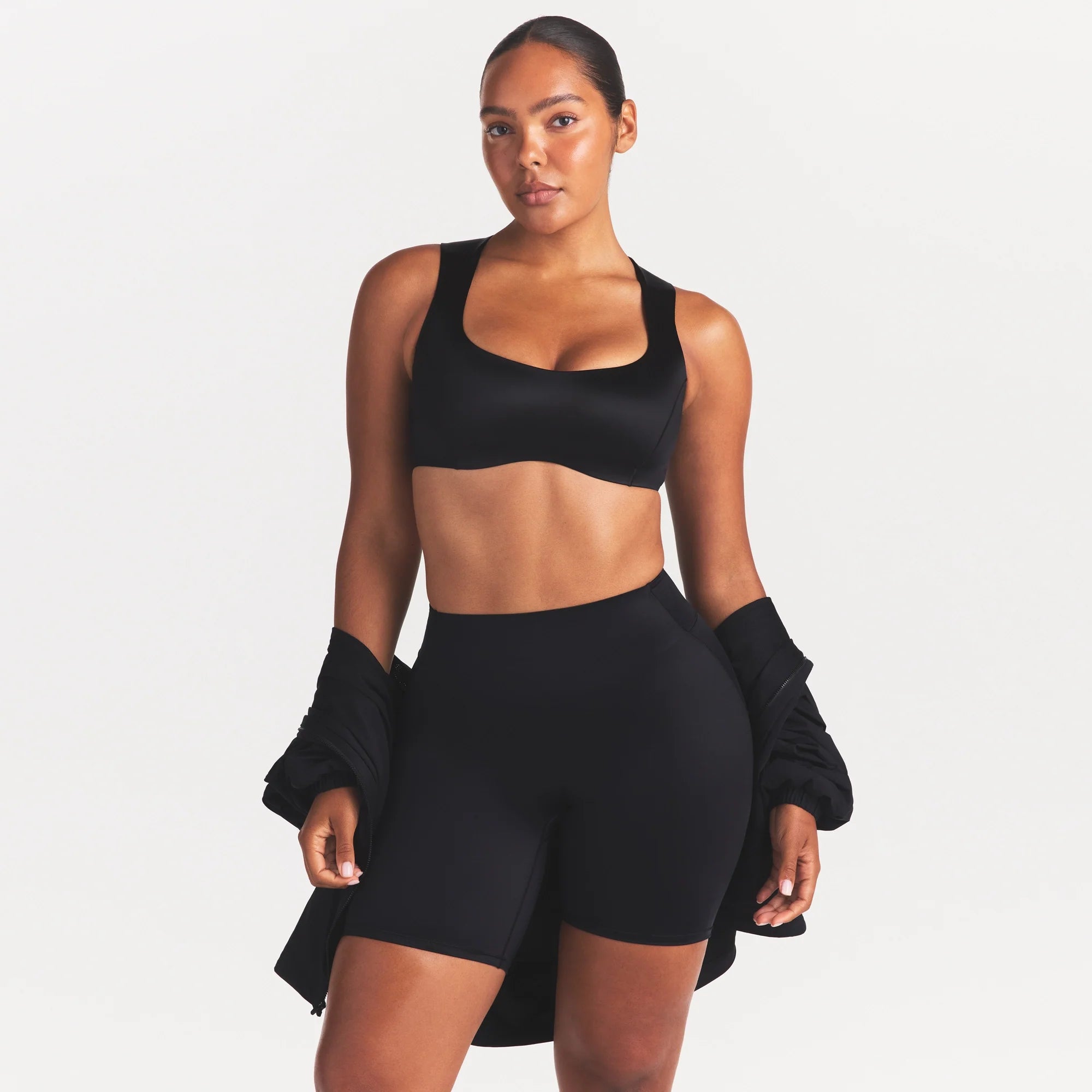 NikeSKIMS SATIN SHINE BONDED WAIST 7" BIKER SHORT | OBSIDIAN ON A MODEL SIDE VIEW