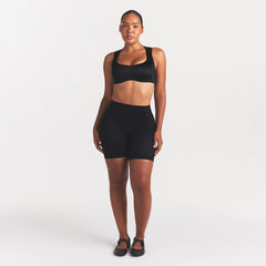 NikeSKIMS SATIN SHINE BONDED WAIST 7" BIKER SHORT | OBSIDIAN ON A MODEL FRONT VIEW