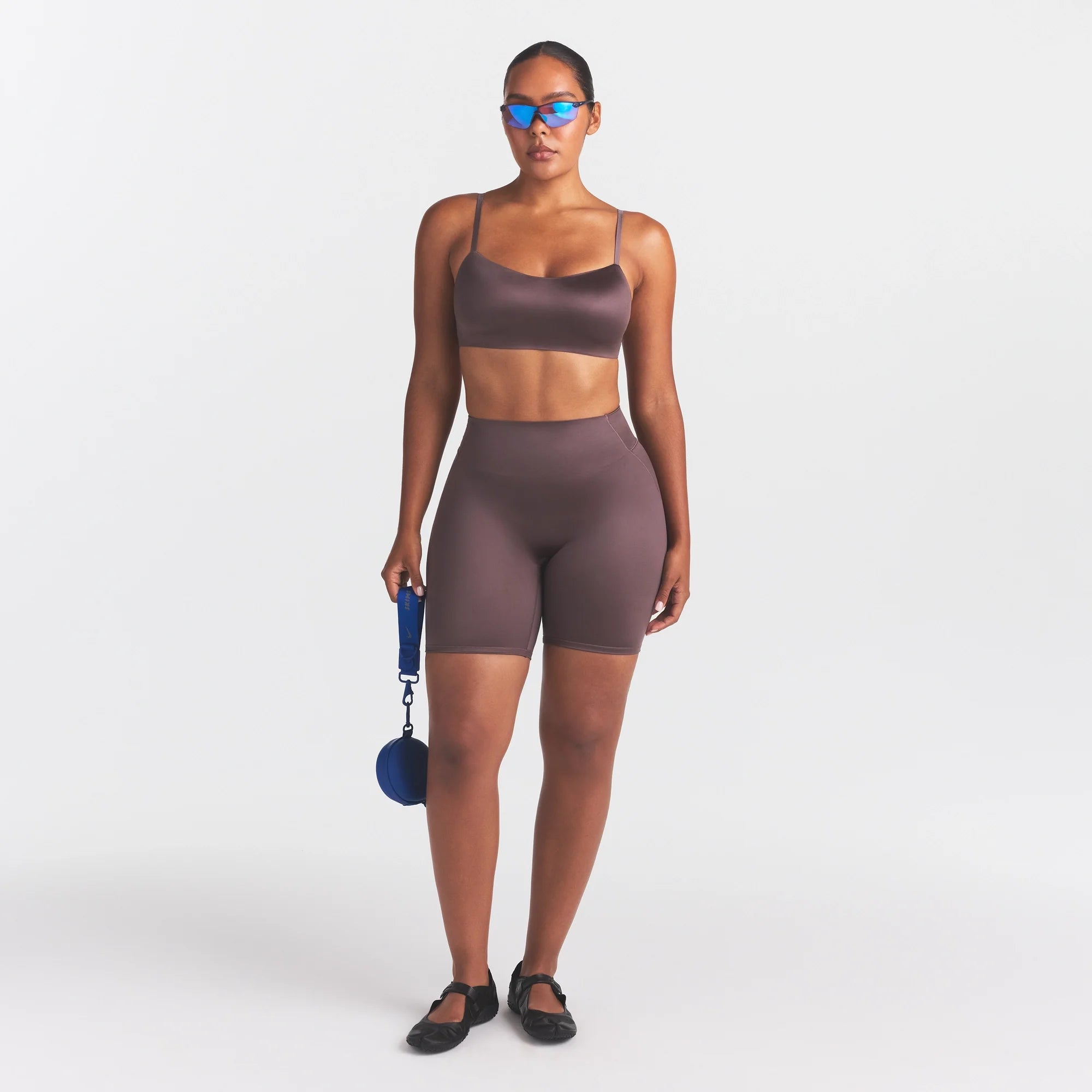 NikeSKIMS SATIN SHINE BONDED WAIST 7" BIKER SHORT | RESIN ON A MODEL FRONT VIEW