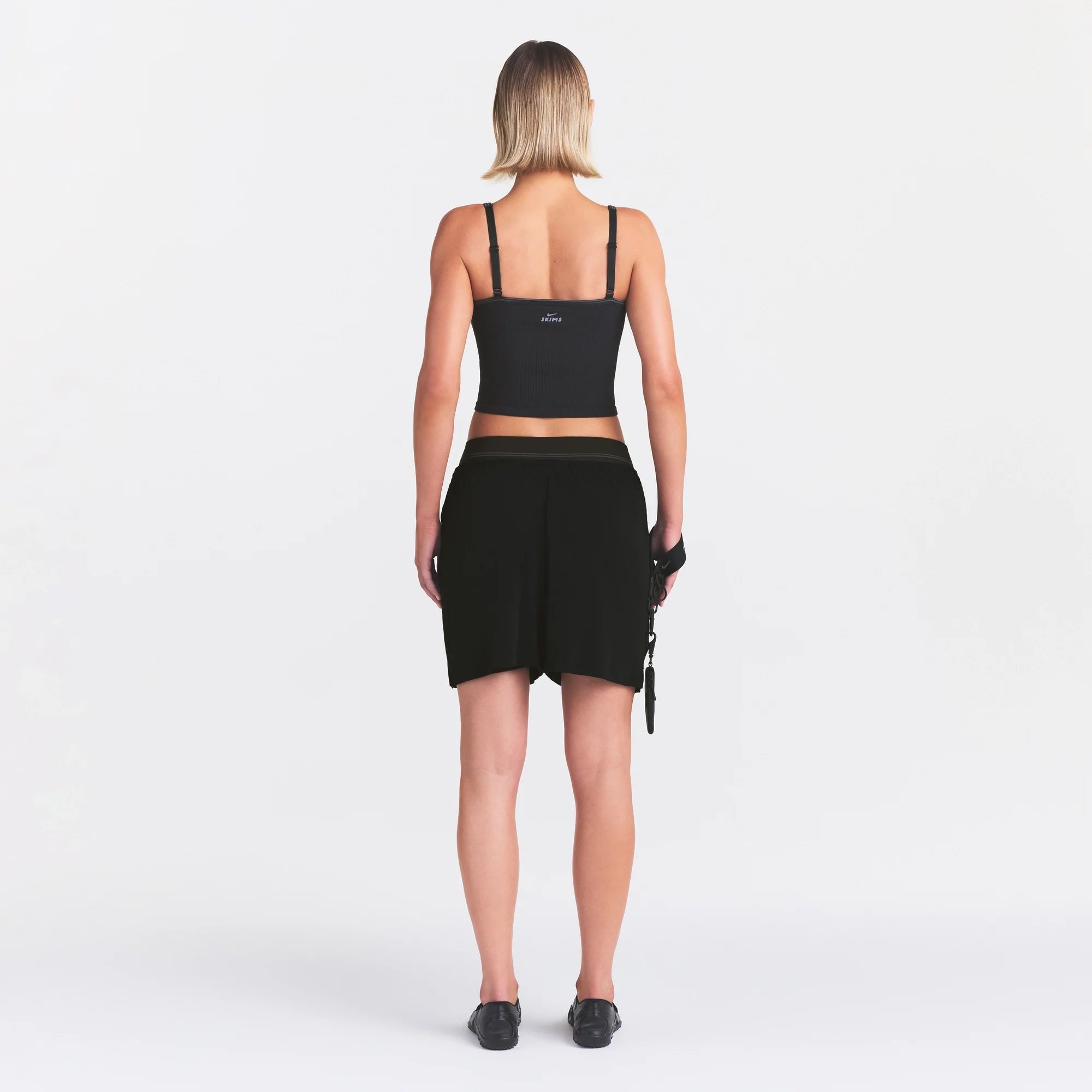 NikeSKIMS STRETCH KNIT DOLPHIN SHORT | OBSIDIAN ON A MODEL FRONT VIEW @ | FOCUS: 0.0, 1.0, 0.9