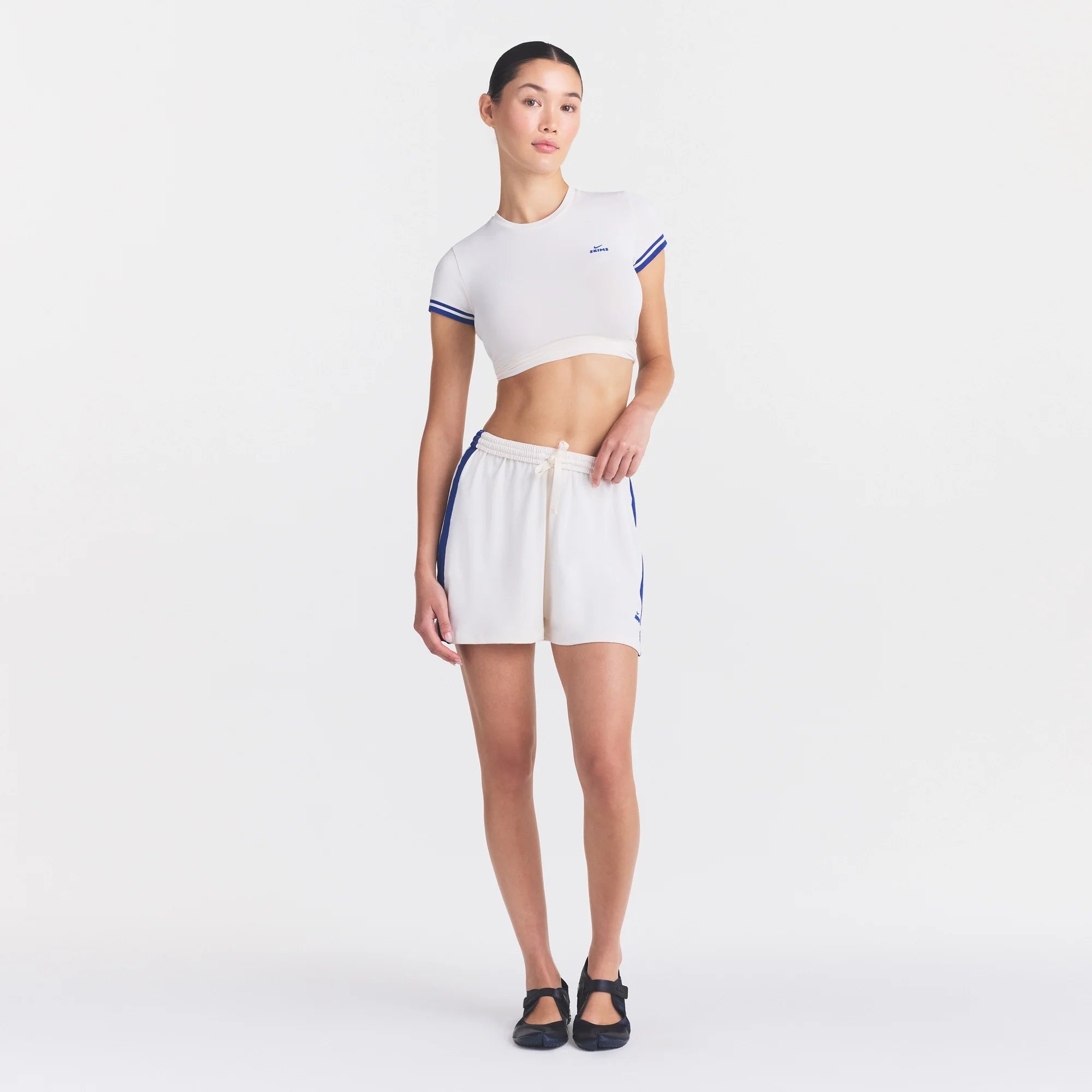 NikeSKIMS STRETCH KNIT DOLPHIN SHORT | IVORY ON A MODEL FRONT VIEW @ | FOCUS: 0.0, 1.0, 0.9