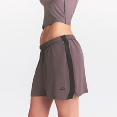 NikeSKIMS STRETCH KNIT DOLPHIN SHORT | RESIN ON A MODEL SIDE VIEW @ | FOCUS: 0.0, 1.0, 0.9