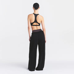 NikeSKIMS STRETCH KNIT WIDE LEG PANT | OBSIDIAN ON A MODEL FRONT VIEW @ | FOCUS: 0.0, 1.0, 0.9