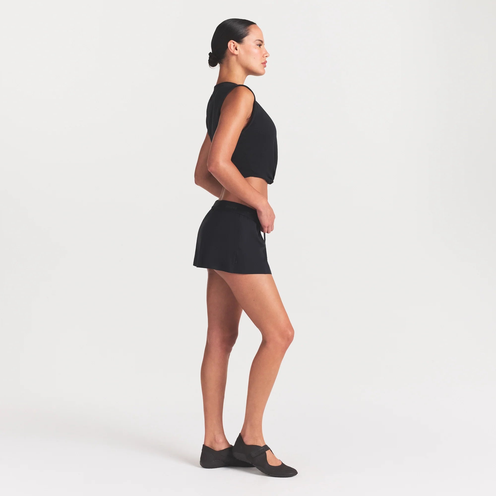 NikeSKIMS STRETCH NYLON SKORT | OBSIDIAN ON A MODEL FRONT VIEW