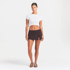 NikeSKIMS STRETCH NYLON SKORT | DARK ROAST ON A MODEL FRONT VIEW @ | FOCUS: 0.0, 1.0, 0.9