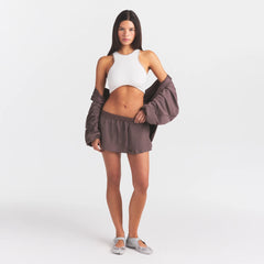 NikeSKIMS STRETCH NYLON SKORT | RESIN ON A MODEL FRONT VIEW @ | FOCUS: 0.0, 1.0, 0.9