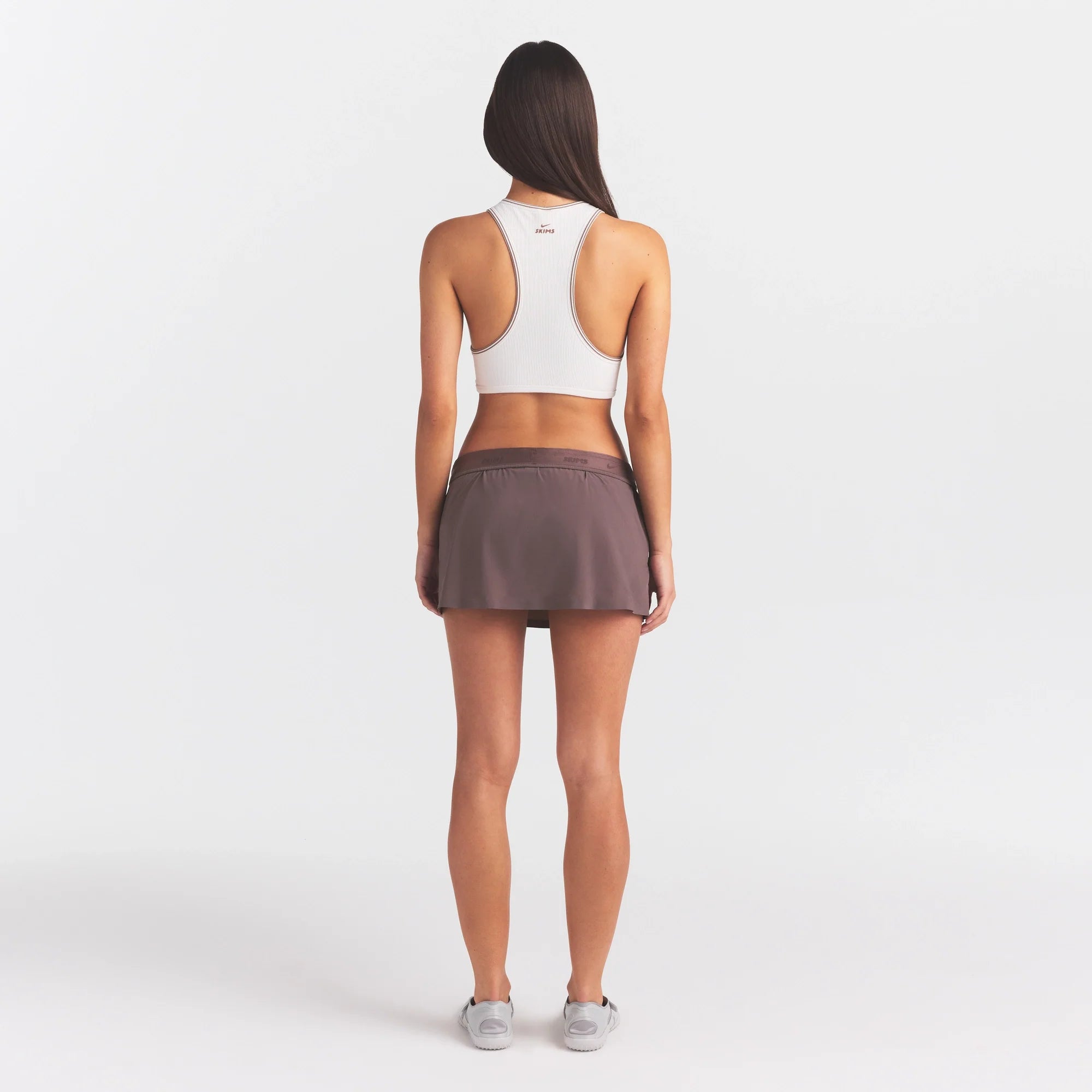 NikeSKIMS STRETCH NYLON SKORT | RESIN ON A MODEL FRONT VIEW @ | FOCUS: 0.0, 1.0, 0.9