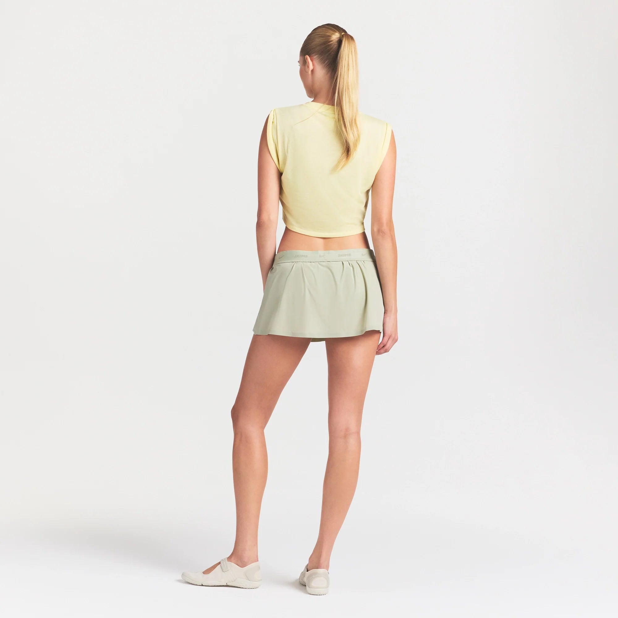 NikeSKIMS STRETCH NYLON SKORT | TALC ON A MODEL FRONT VIEW @ | FOCUS: 0.0, 1.0, 0.9