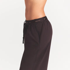 NikeSKIMS STRETCH NYLON OVERSIZED PANT | DARK ROAST ON A MODEL SIDE VIEW @ | FOCUS: 0.0, 1.0, 0.9