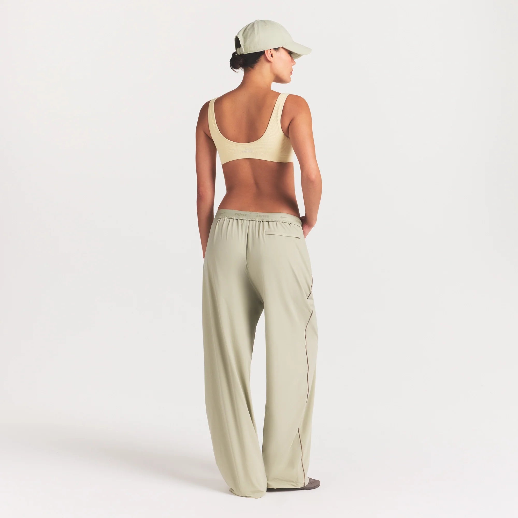NikeSKIMS STRETCH NYLON OVERSIZED PANT | TALC ON A MODEL FRONT VIEW @ | FOCUS: 0.0, 1.0, 0.9