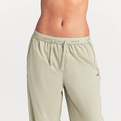 NikeSKIMS STRETCH NYLON OVERSIZED PANT | TALC ON A MODEL SIDE VIEW @ | FOCUS: 0.0, 1.0, 0.9