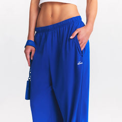 NikeSKIMS STRETCH NYLON OVERSIZED PANT | COBALT ON A MODEL SIDE VIEW @ | FOCUS: 0.0, 1.0, 0.9