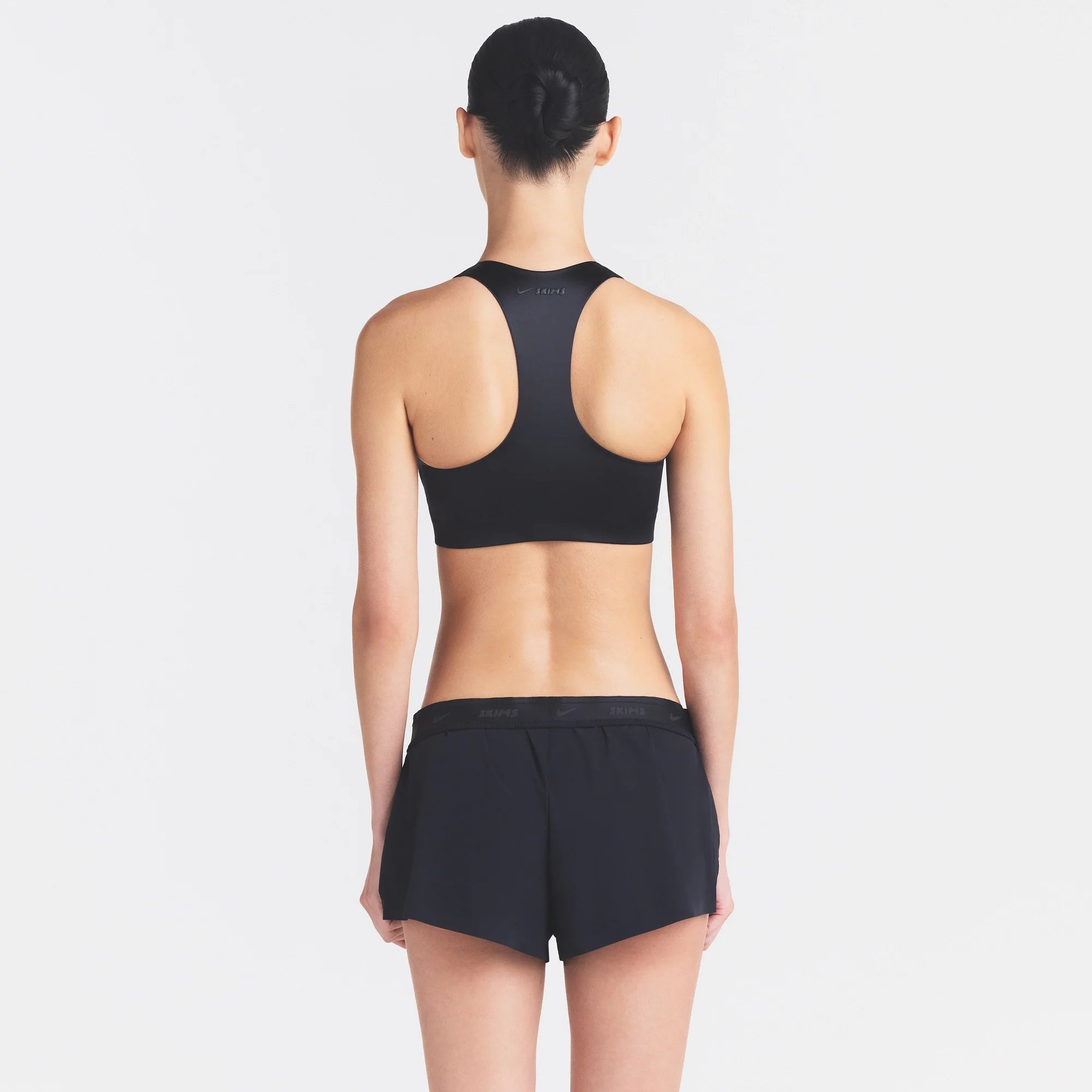 NikeSKIMS STRETCH NYLON RUNNER SHORT | OBSIDIAN ON A MODEL SIDE VIEW @ | FOCUS: 0.0, 1.0, 0.9
