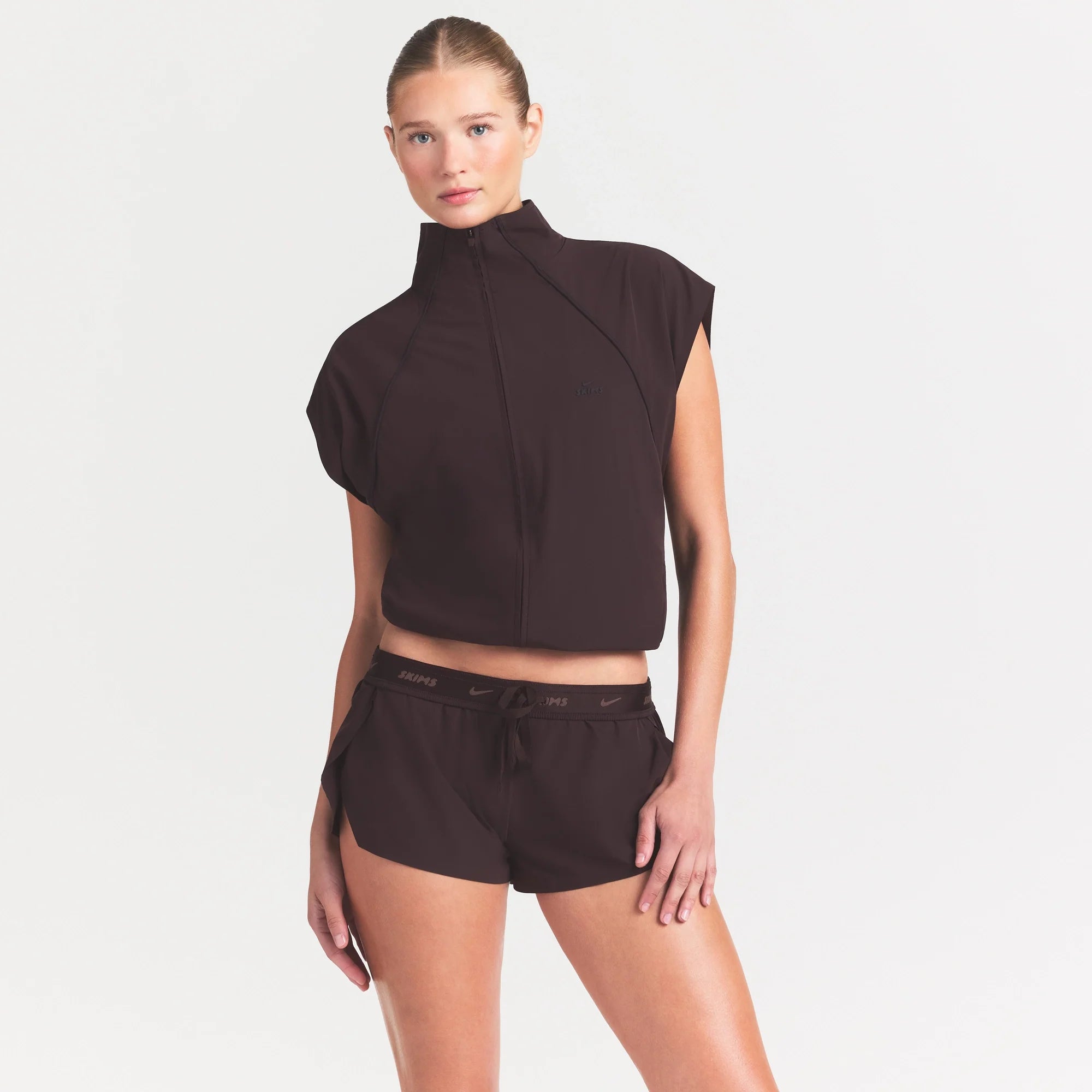 NikeSKIMS STRETCH NYLON RUNNER SHORT | DARK ROAST ON A MODEL SIDE VIEW @ | FOCUS: 0.0, 1.0, 0.9