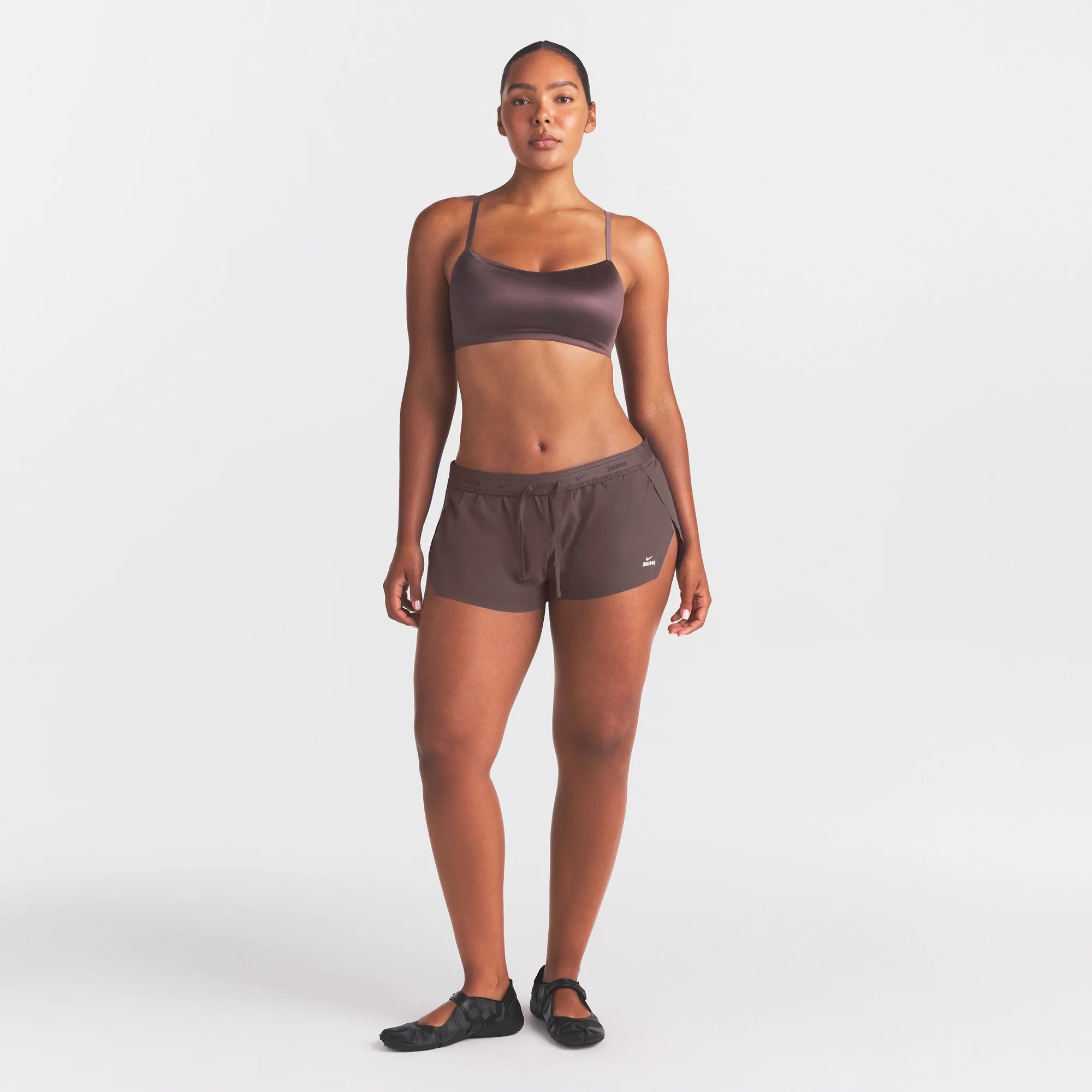 NikeSKIMS STRETCH NYLON RUNNER SHORT | RESIN ON A MODEL FRONT VIEW @ | FOCUS: 0.0, 1.0, 0.9