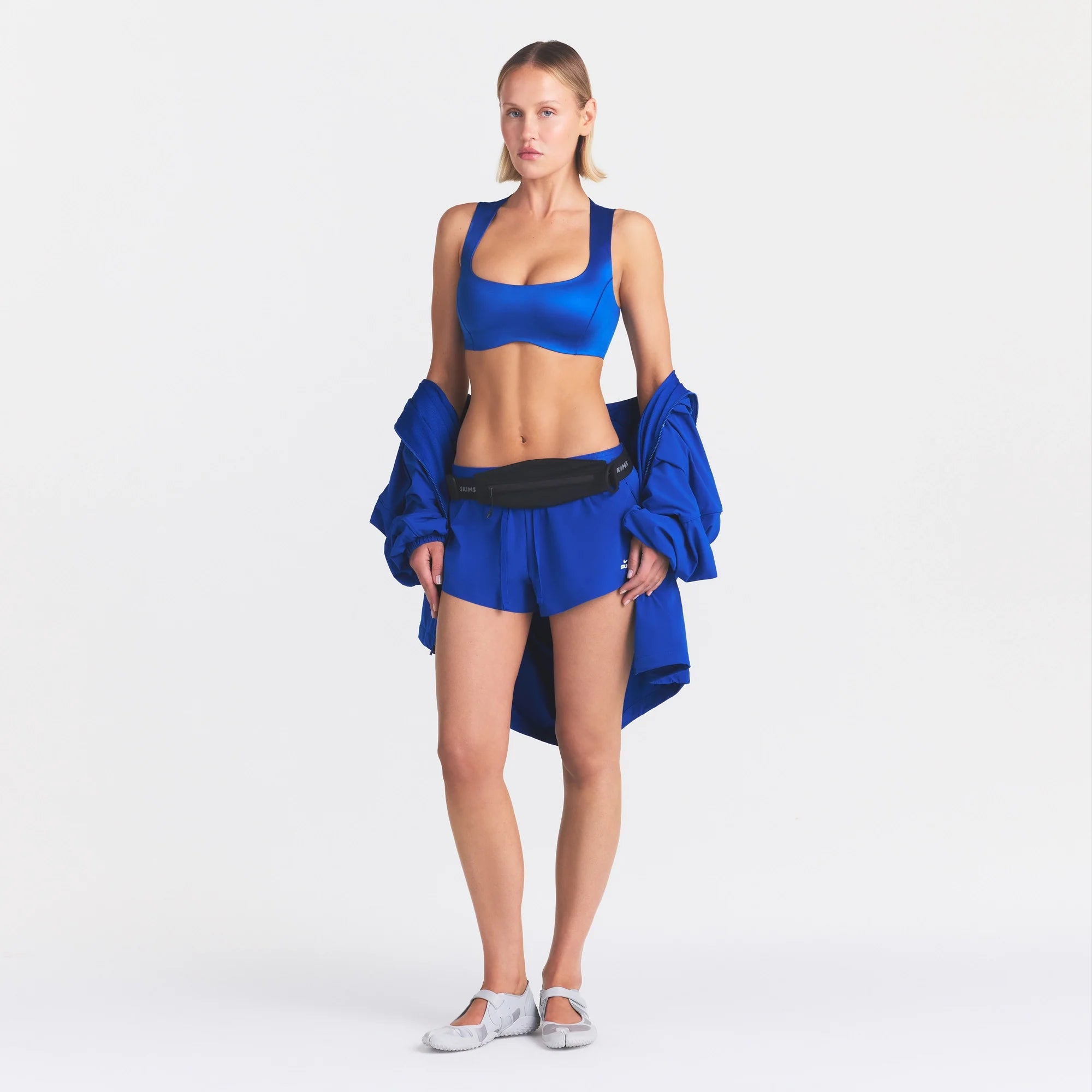 NikeSKIMS STRETCH NYLON RUNNER SHORT | COBALT ON A MODEL FRONT VIEW @ | FOCUS: 0.0, 1.0, 0.9