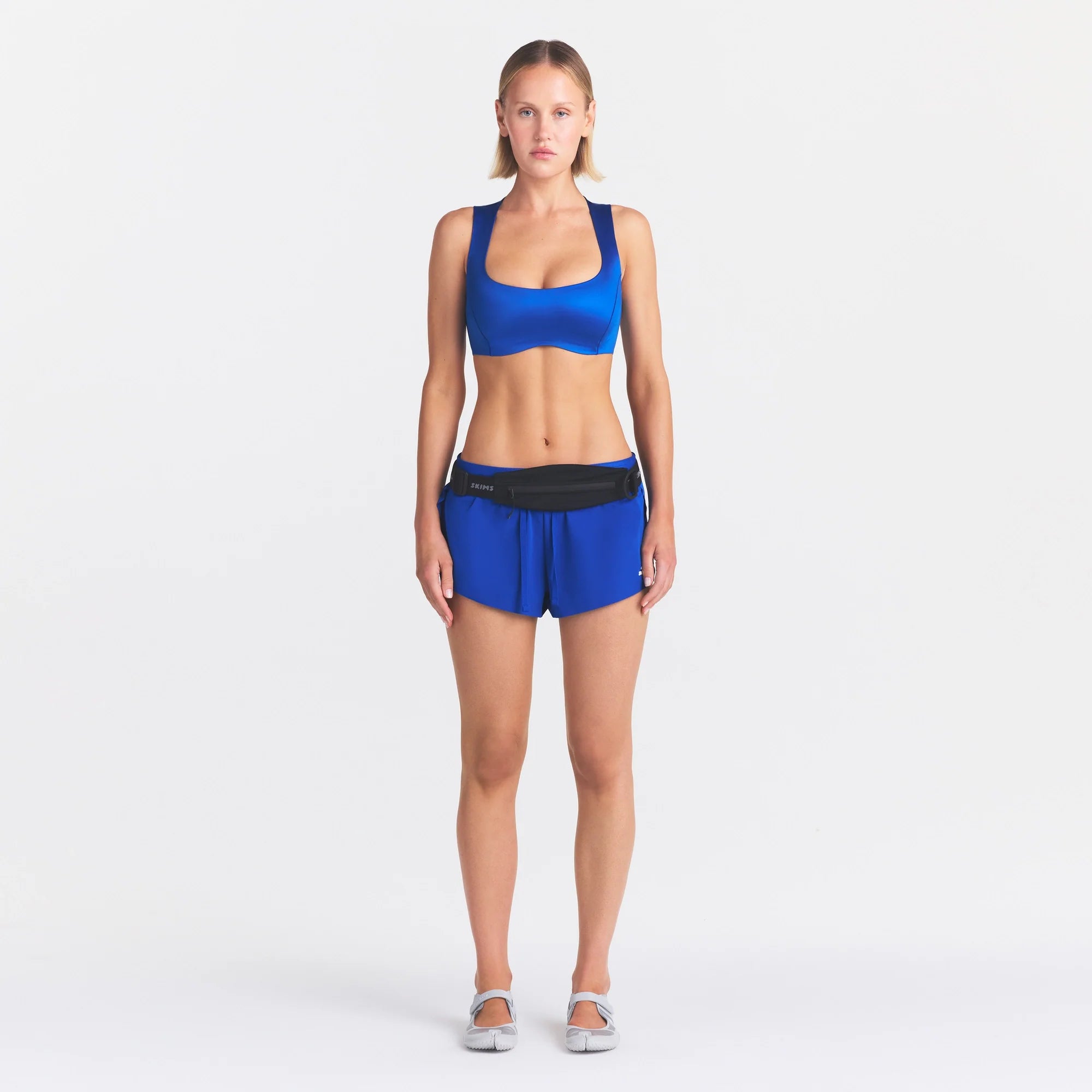 NikeSKIMS STRETCH NYLON RUNNER SHORT | COBALT ON A MODEL FRONT VIEW @ | FOCUS: 0.0, 1.0, 0.9