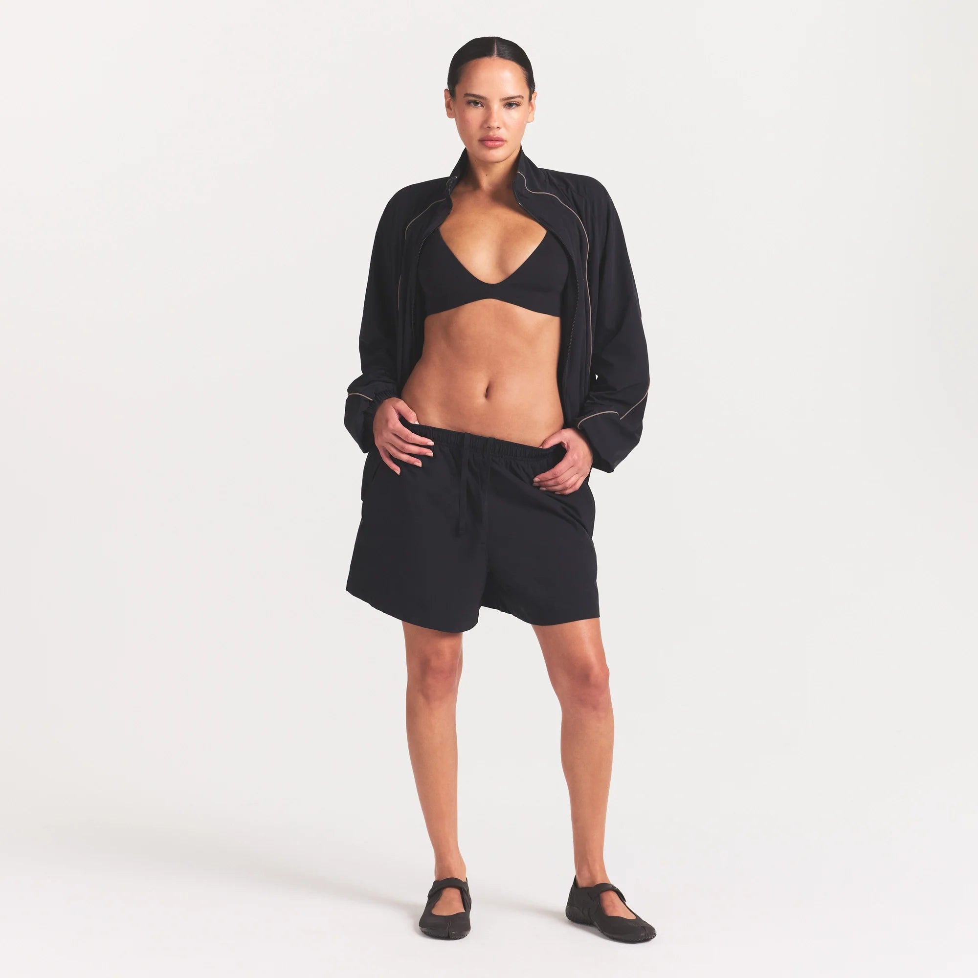 NikeSKIMS STRETCH NYLON 5" TRACK SHORT | OBSIDIAN ON A MODEL FRONT VIEW