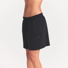 NikeSKIMS STRETCH NYLON 5" TRACK SHORT | OBSIDIAN ON A MODEL SIDE VIEW