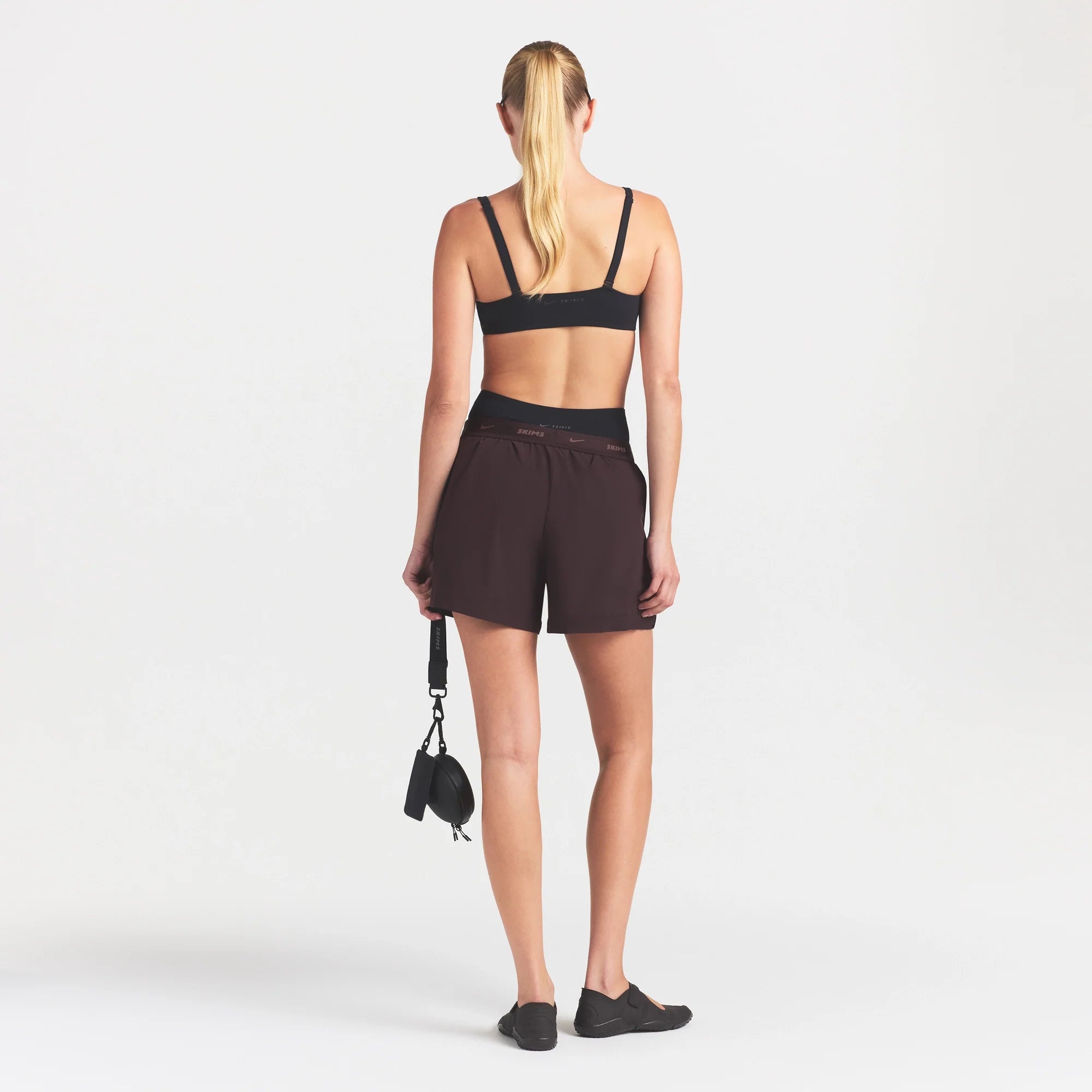 NikeSKIMS STRETCH NYLON 5" TRACK SHORT | DARK ROAST ON A MODEL FRONT VIEW @ | FOCUS: 0.0, 1.0, 0.9