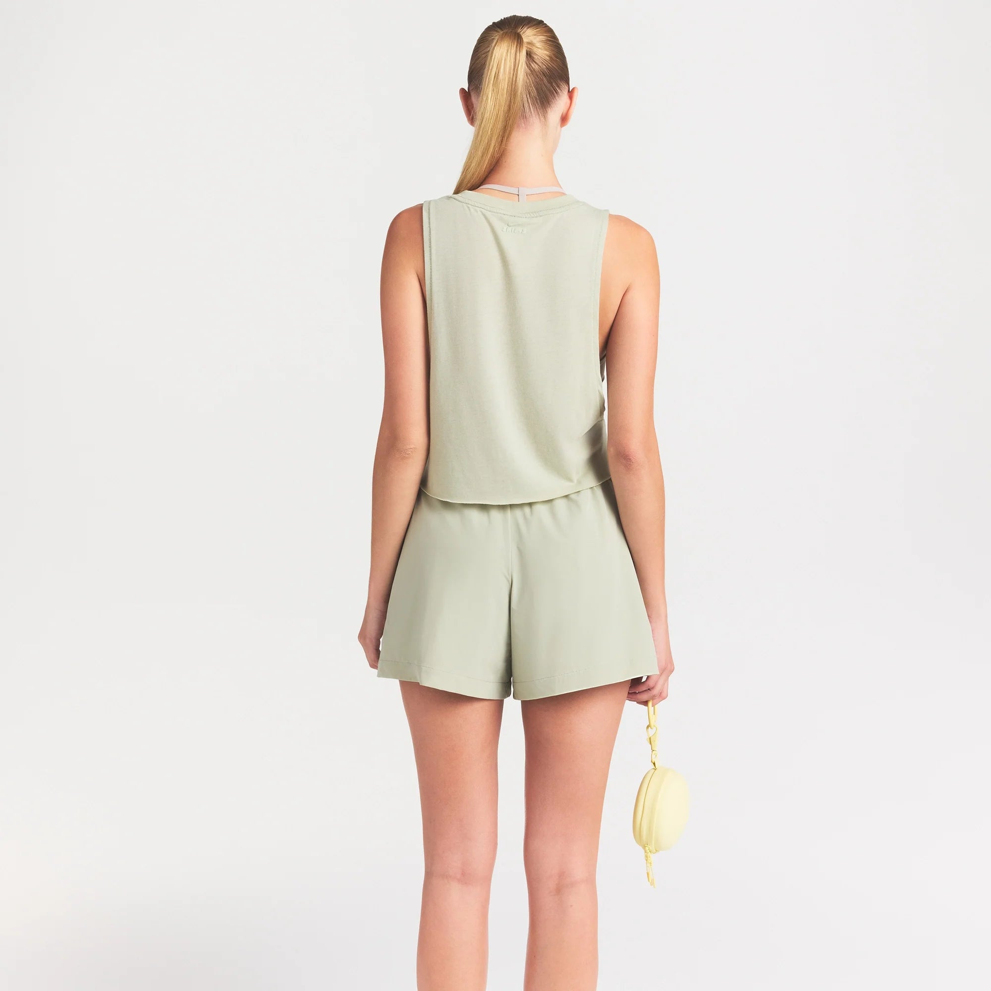 NikeSKIMS STRETCH NYLON 5" TRACK SHORT | TALC ON A MODEL SIDE VIEW @ | FOCUS: 0.0, 1.0, 0.9