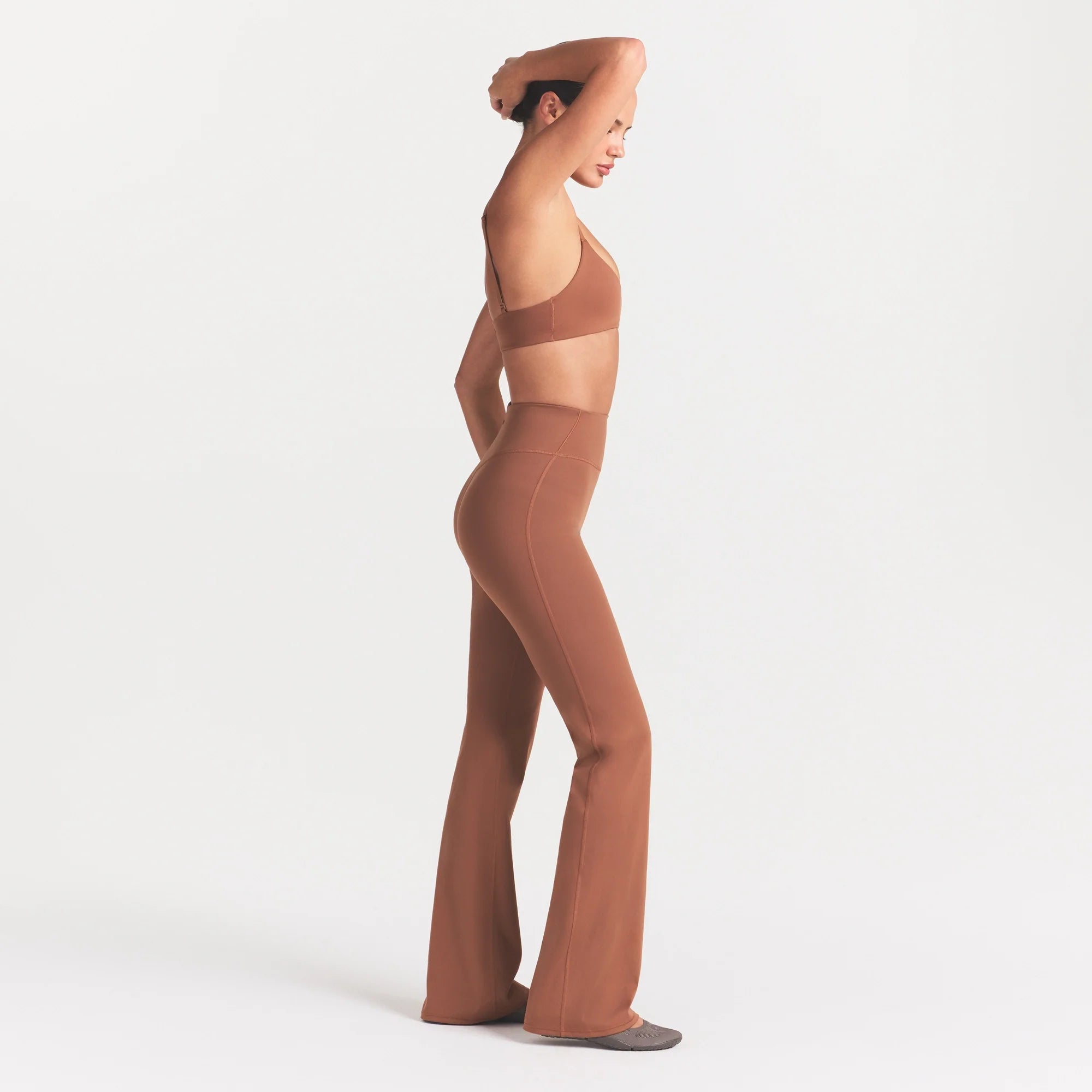 NikeSKIMS MATTE SLIM FLARE LEGGING | CAROB BROWN ON A MODEL FRONT VIEW @ | FOCUS: 0.0, 1.0, 0.9