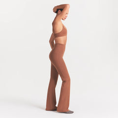 NikeSKIMS MATTE SLIM FLARE LEGGING | CAROB BROWN ON A MODEL FRONT VIEW @ | FOCUS: 0.0, 1.0, 0.9