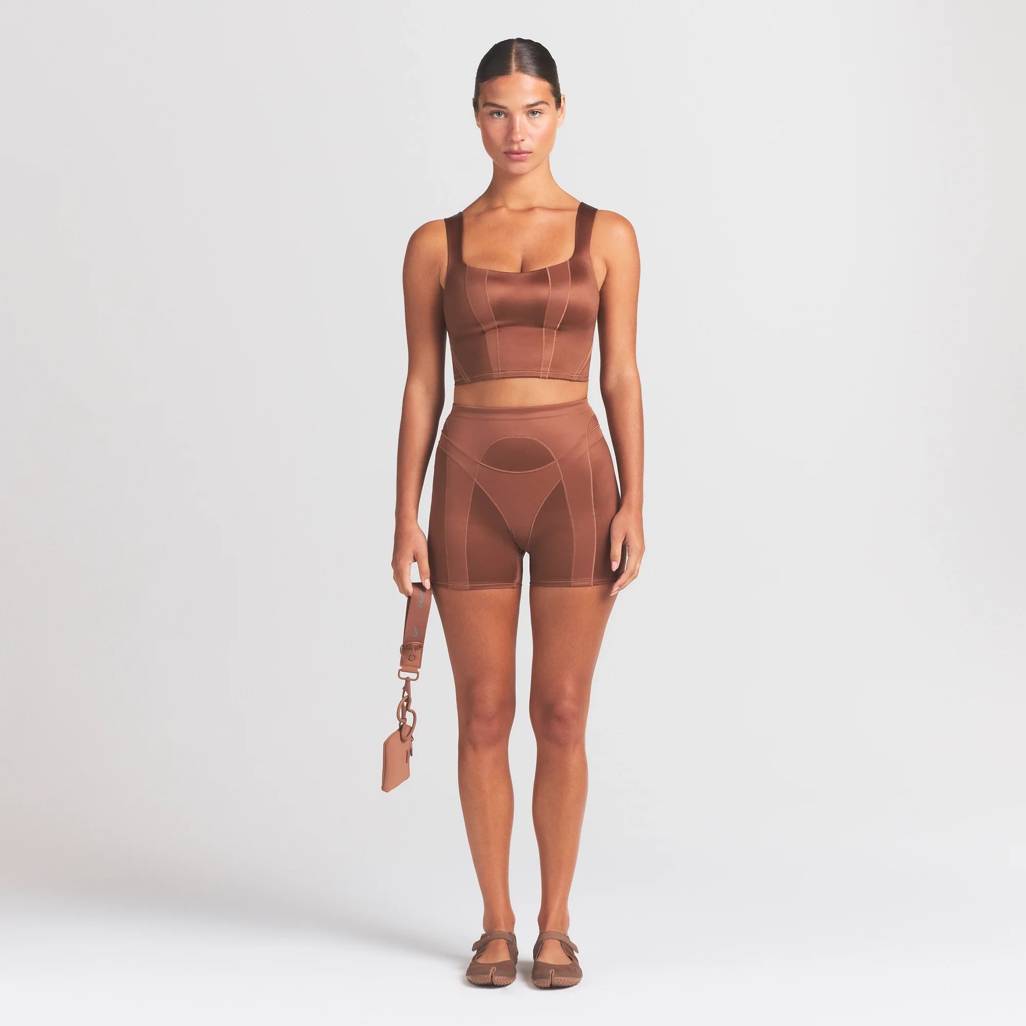 NikeSKIMS SATIN SHINE PANELED 5” BIKER SHORT | CAROB BROWN ON A MODEL FRONT VIEW @ | FOCUS: 0.0, 1.0, 0.9
