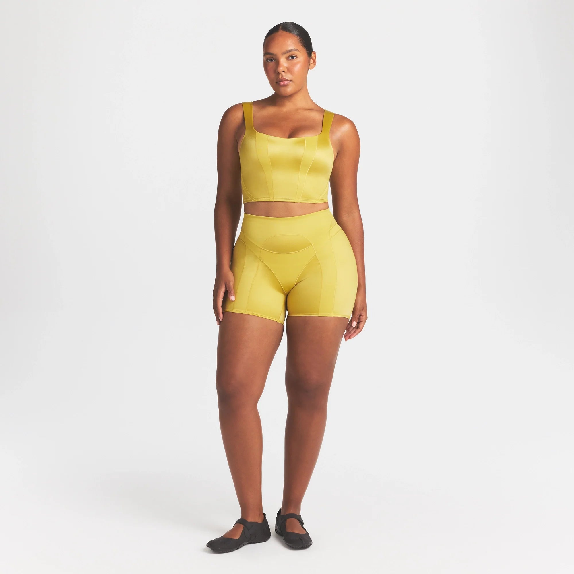 NikeSKIMS SATIN SHINE PANELED 5” BIKER SHORT | CITRINE ON A MODEL FRONT VIEW @ | FOCUS: 0.0, 1.0, 0.9