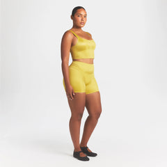 NikeSKIMS SATIN SHINE PANELED 5” BIKER SHORT | CITRINE ON A MODEL FRONT VIEW @ | FOCUS: 0.0, 1.0, 0.9