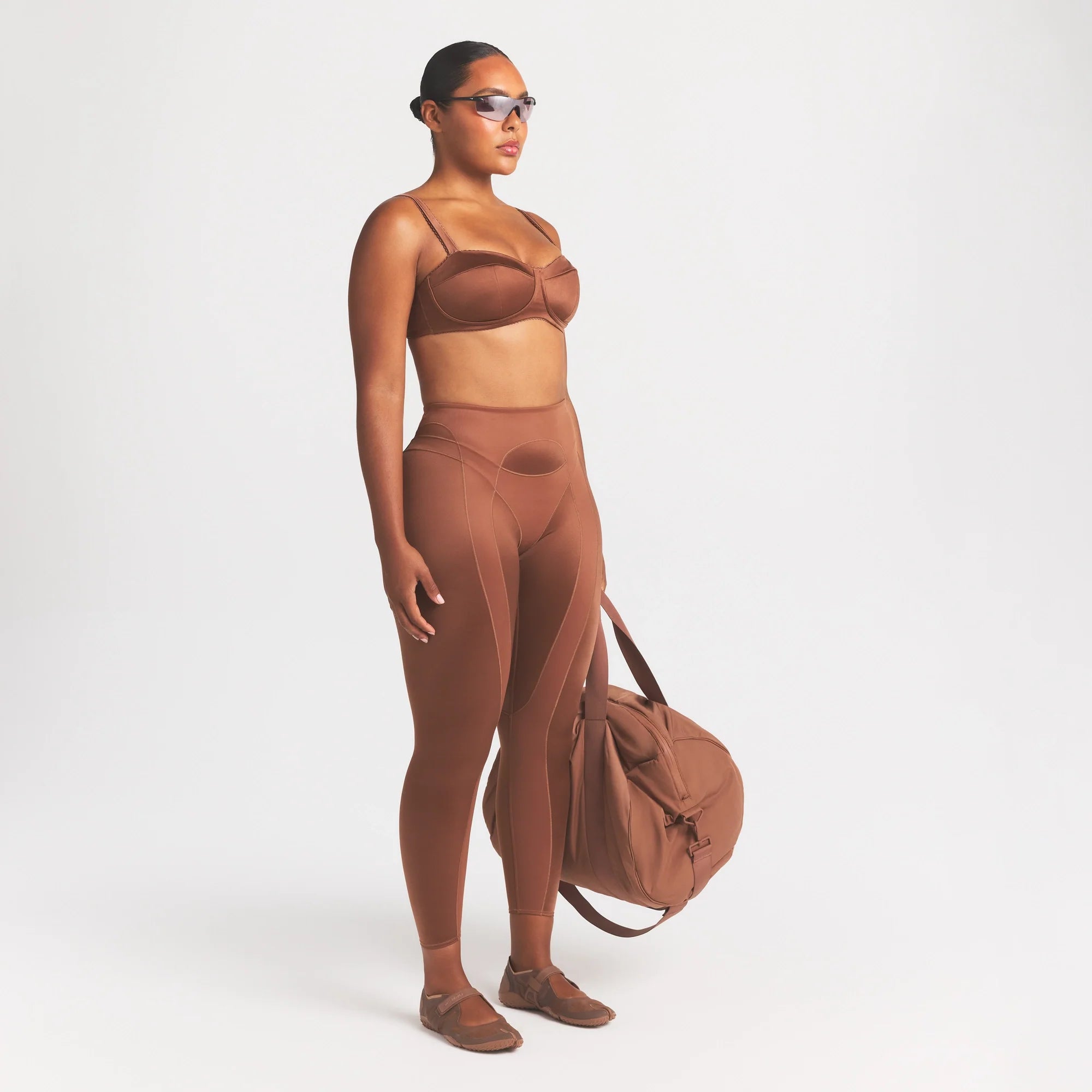 NikeSKIMS SATIN SHINE PANELED 26” LEGGING | CAROB BROWN ON A MODEL FRONT VIEW @ | FOCUS: 0.0, 1.0, 0.9
