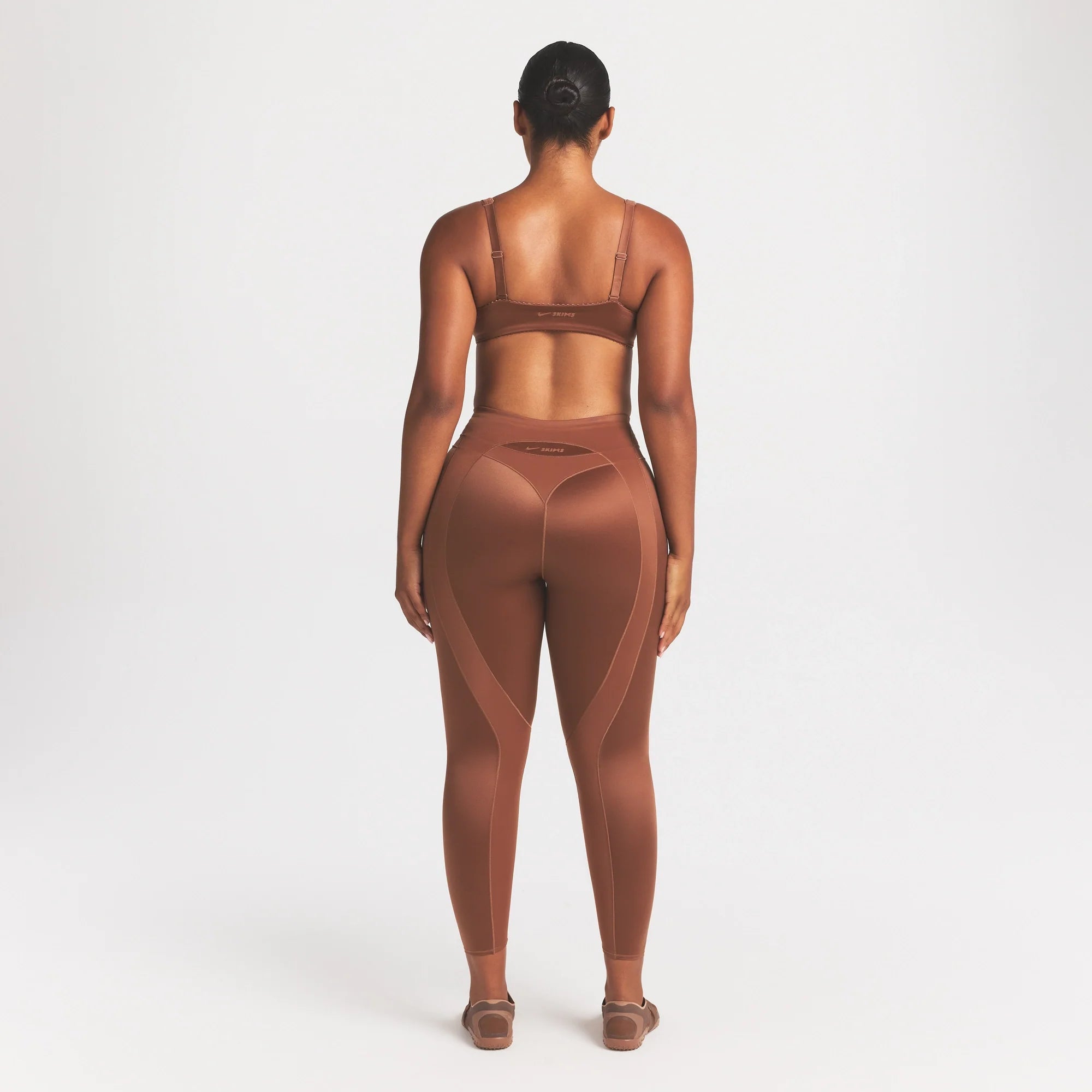 NikeSKIMS SATIN SHINE PANELED 26” LEGGING | CAROB BROWN ON A MODEL FRONT VIEW @ | FOCUS: 0.0, 1.0, 0.9