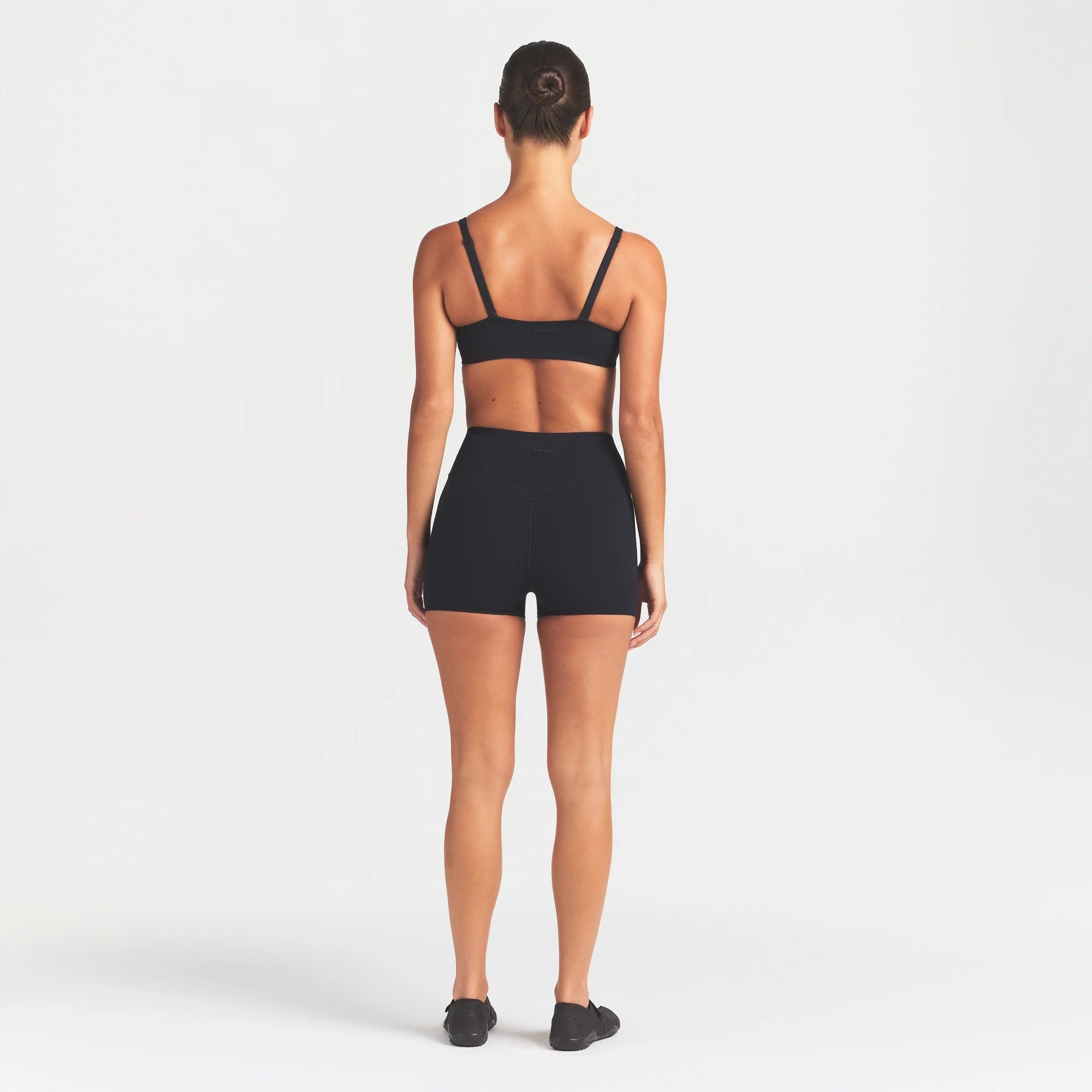 NikeSKIMS STUDIO STRETCH 3" SHORT | OBSIDIAN ON A MODEL FRONT VIEW