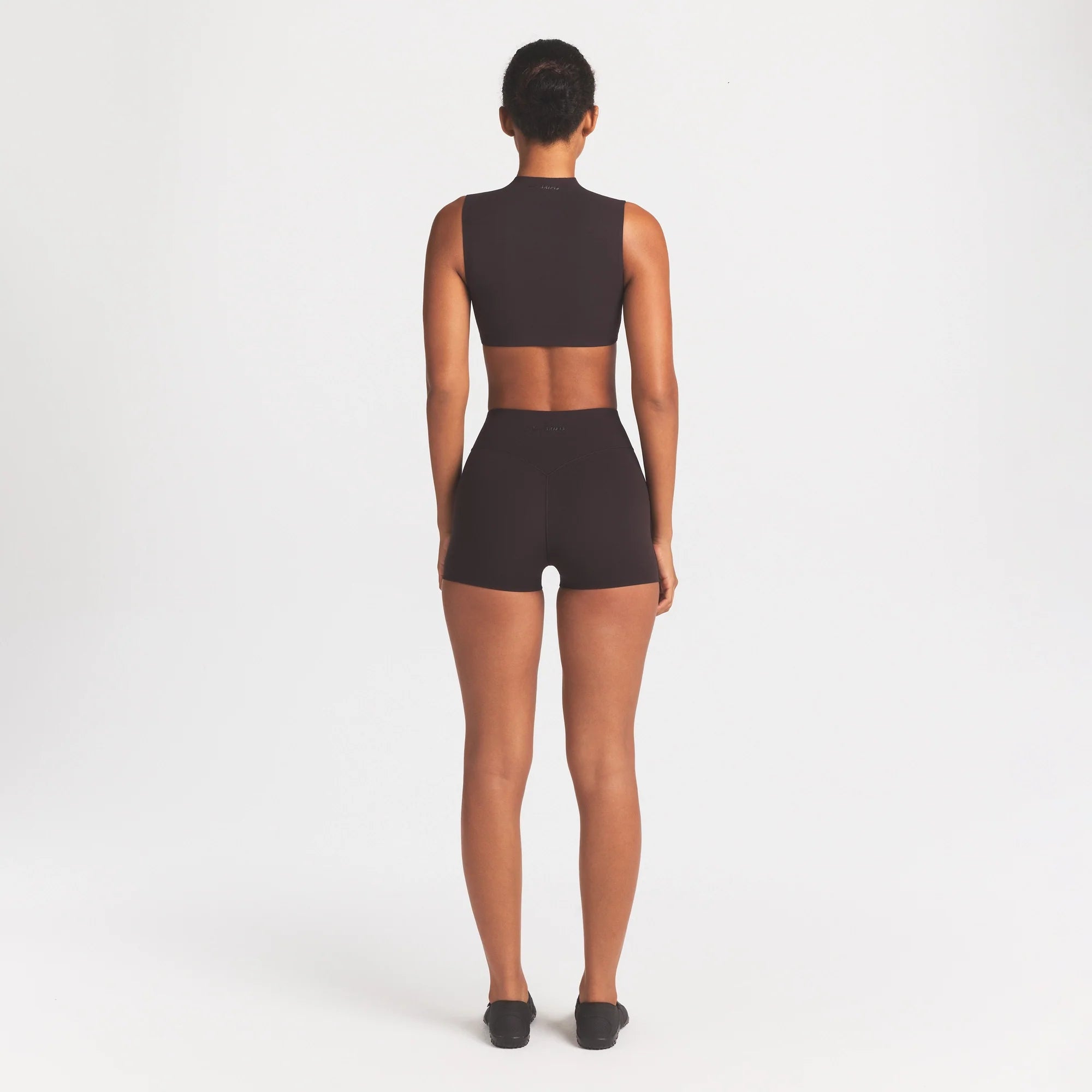 NikeSKIMS STUDIO STRETCH 3" SHORT | DARK ROAST ON A MODEL FRONT VIEW @ | FOCUS: 0.0, 1.0, 0.9