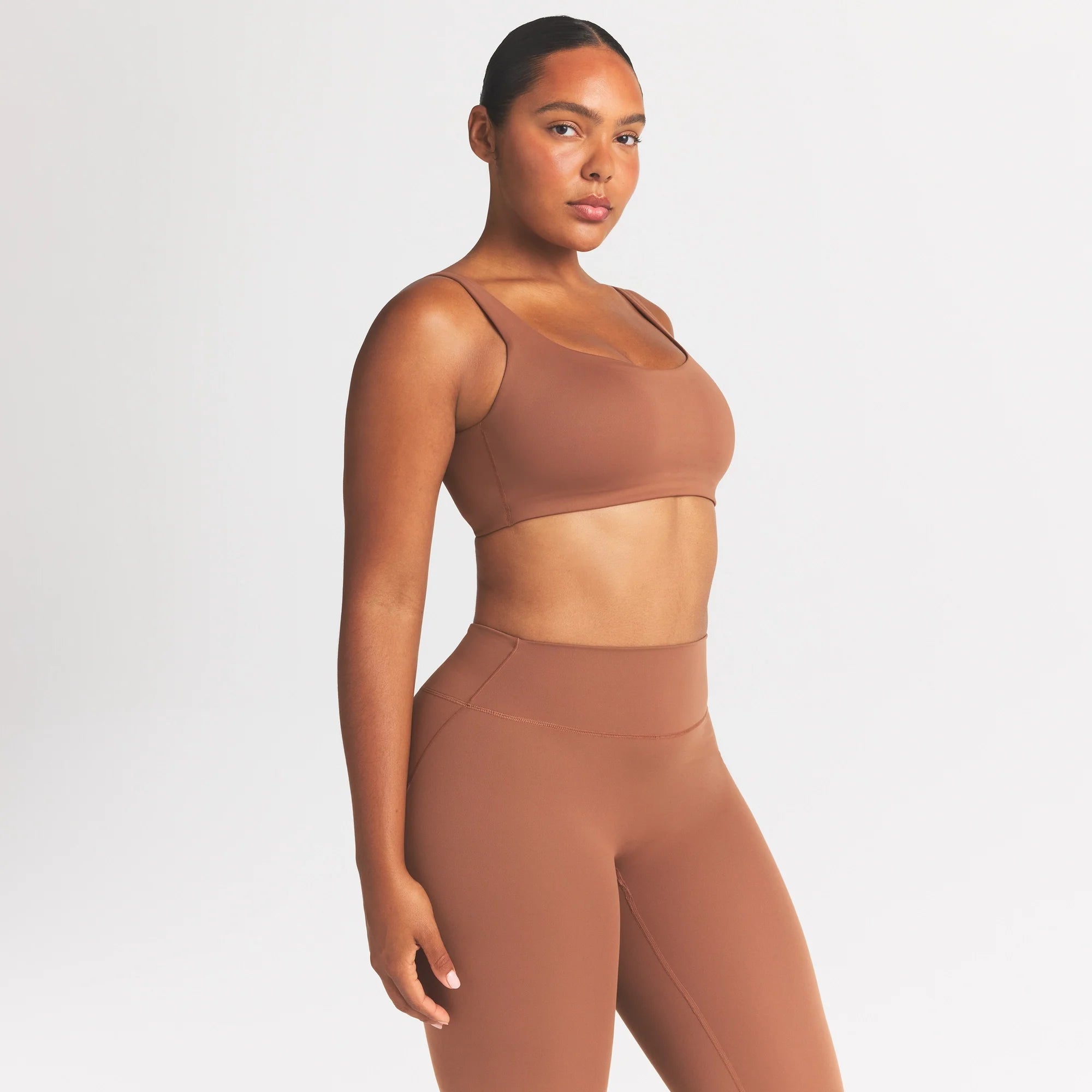 NikeSKIMS MATTE SCOOP NECK BRA | CAROB BROWN ON A MODEL SIDE VIEW @ | FOCUS: 0.0, 1.0, 0.9