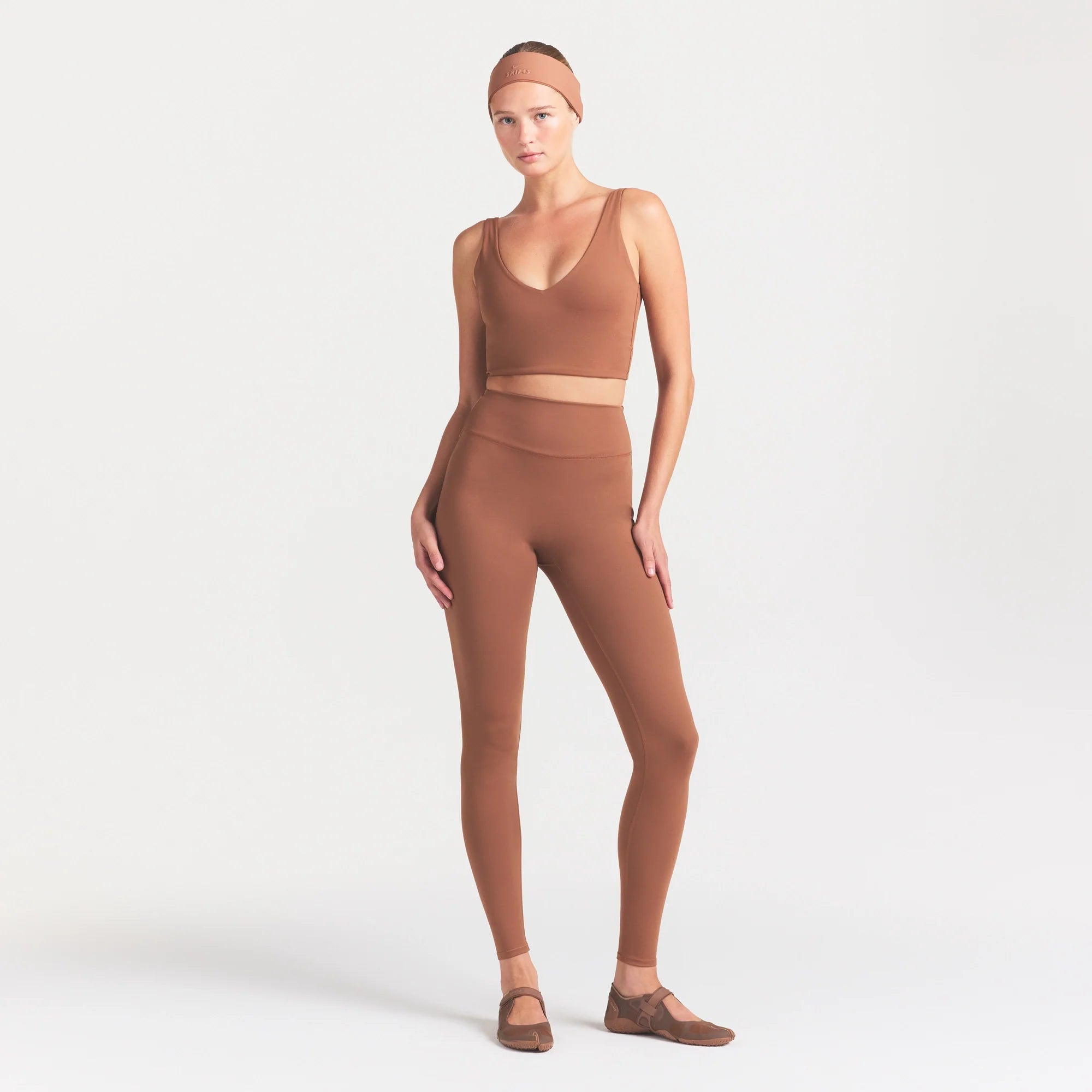 NikeSKIMS MATTE V-NECK BRA TOP | CAROB BROWN ON A MODEL FRONT VIEW @ | FOCUS: 0.0, 1.0, 0.9