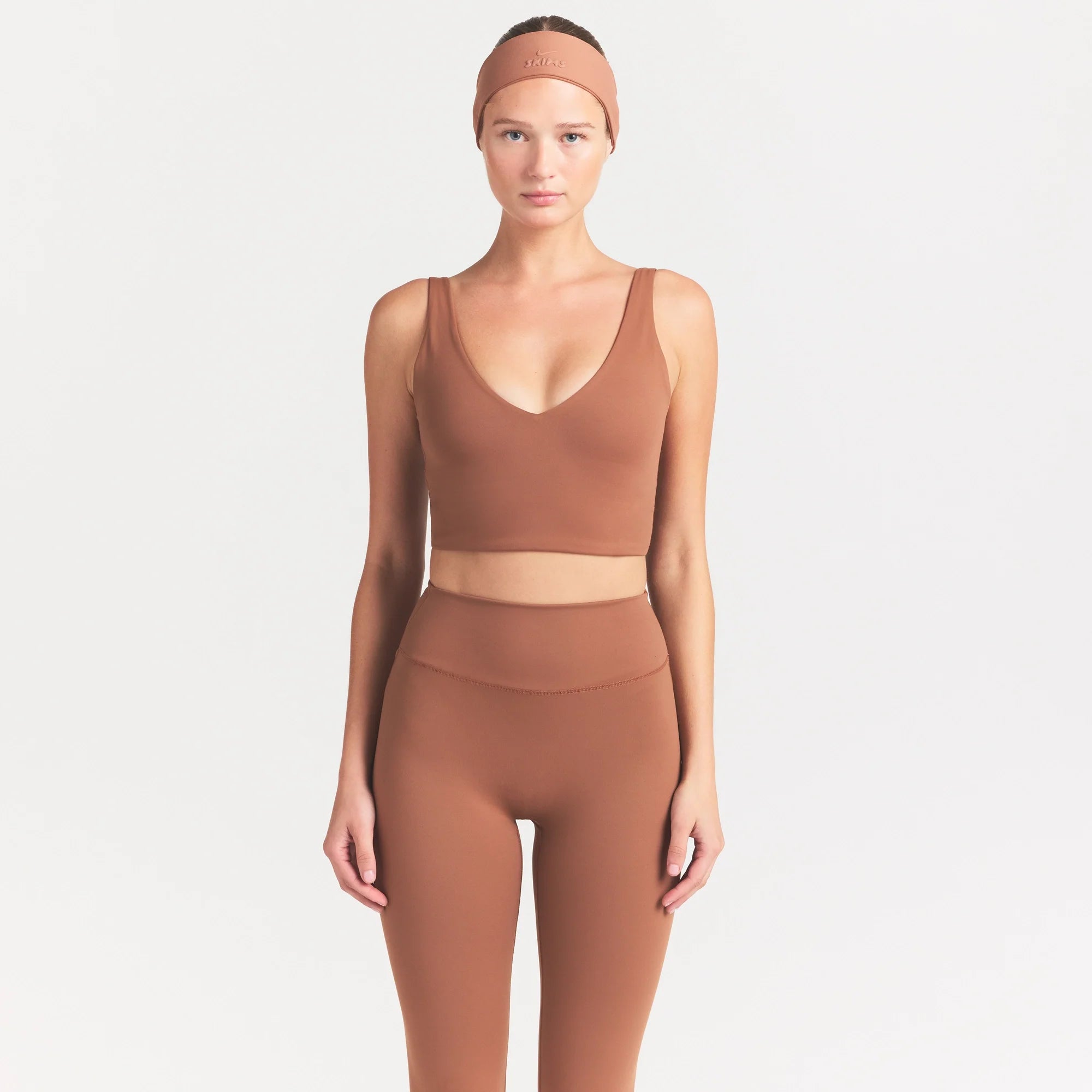 NikeSKIMS MATTE V-NECK BRA TOP | CAROB BROWN ON A MODEL SIDE VIEW @ | FOCUS: 0.0, 1.0, 0.9