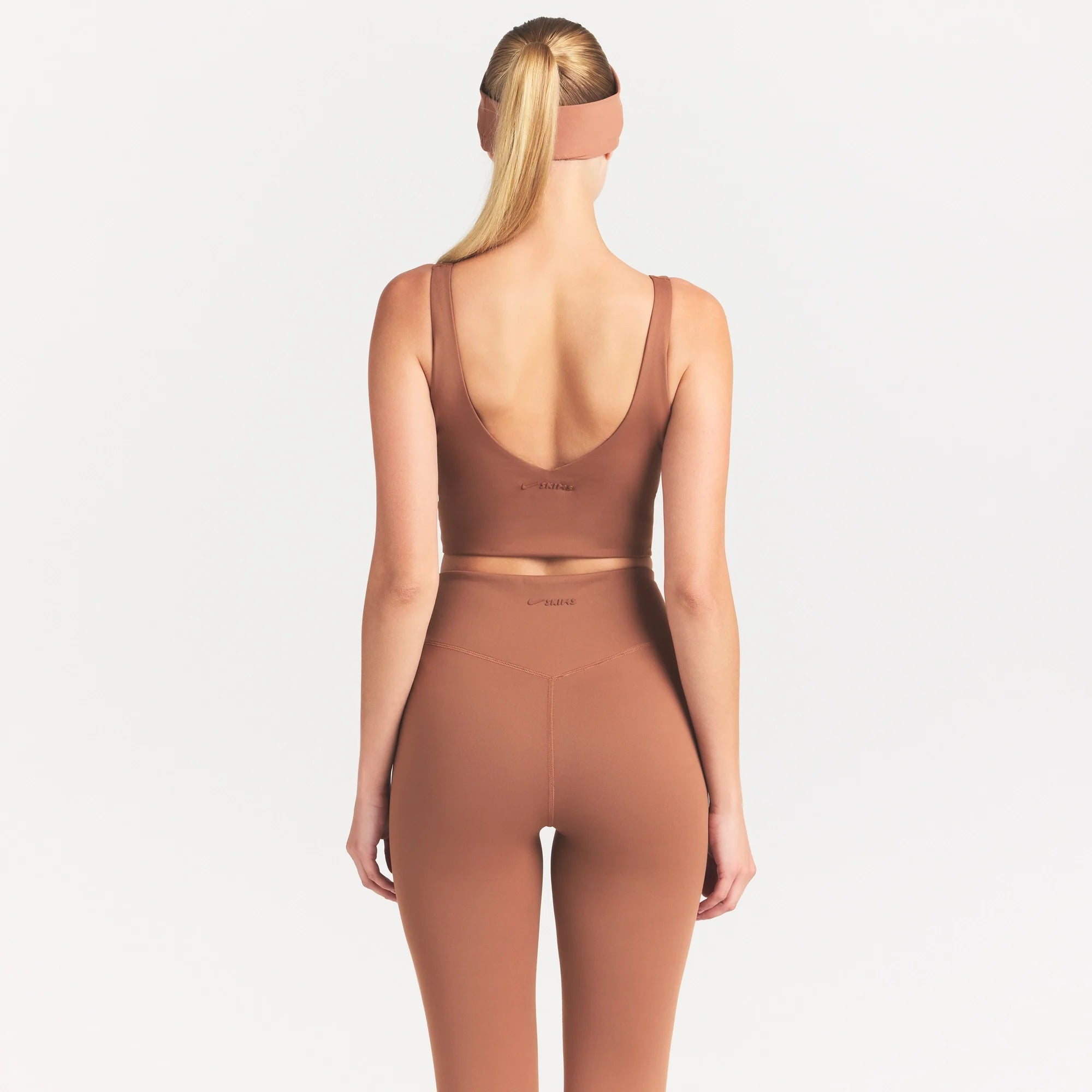 NikeSKIMS MATTE V-NECK BRA TOP | CAROB BROWN ON A MODEL SIDE VIEW @ | FOCUS: 0.0, 1.0, 0.9