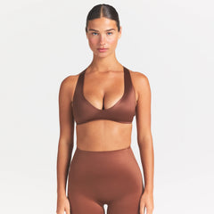 NikeSKIMS SATIN SHINE PLUNGE T-BACK BRA | CAROB BROWN ON A MODEL SIDE VIEW @ | FOCUS: 0.0, 1.0, 0.9
